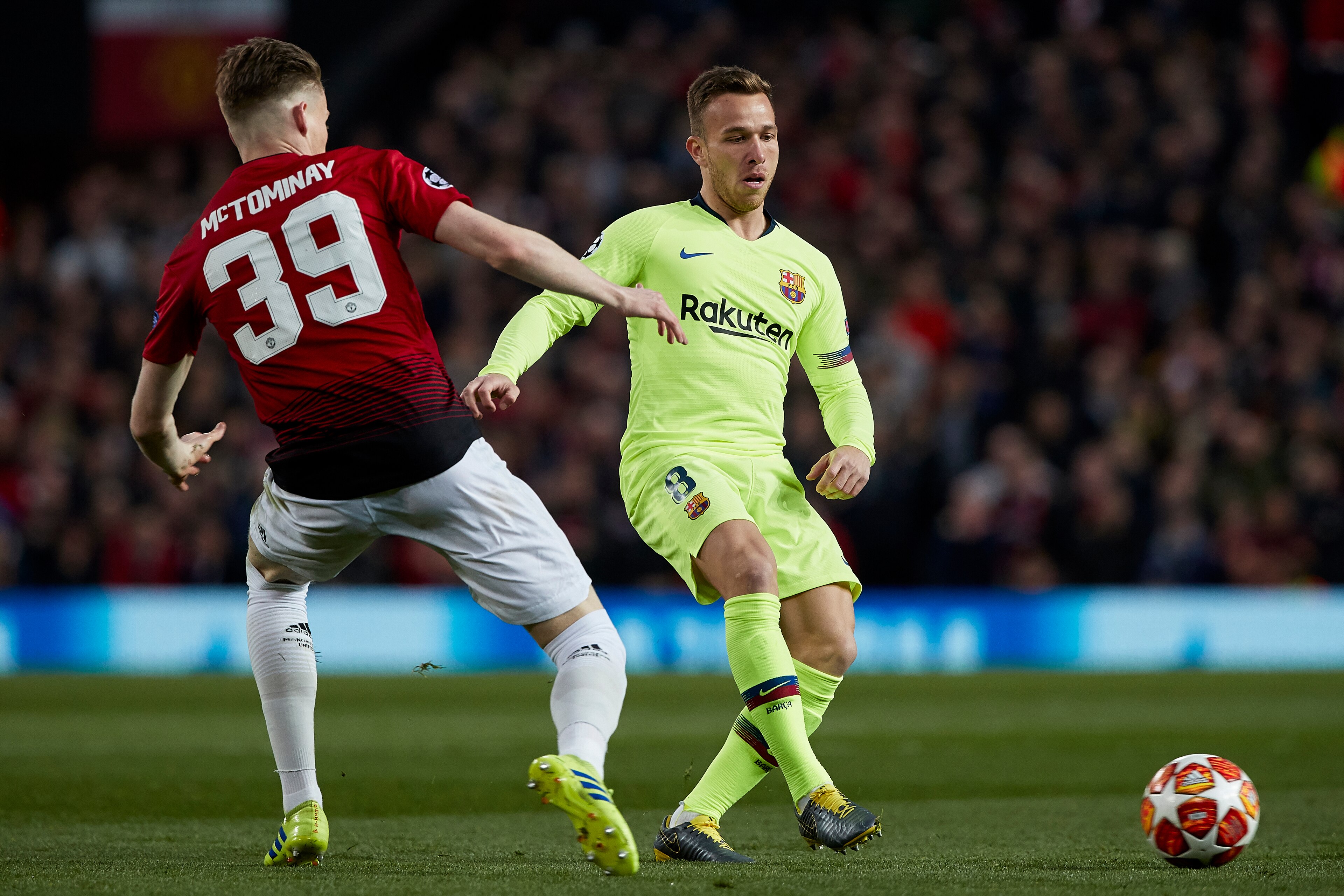 MANCHESTER, ENGLAND - APRIL 10: Scott McTominay of Manchester United competes for the ball with Arthur Melo of FC Barcelona during the UEFA Champions League Quarter Final first leg match between Manchester United and FC Barcelona at Old Trafford on April 