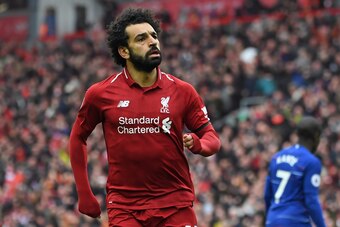 Liverpool's Egyptian midfielder Mohamed Salah celebrates after scoring their second goal during the English Premier League football match between Liverpool and Chelsea at Anfield in Liverpool, north west England on April 14, 2019. (Photo by Paul ELLIS / A