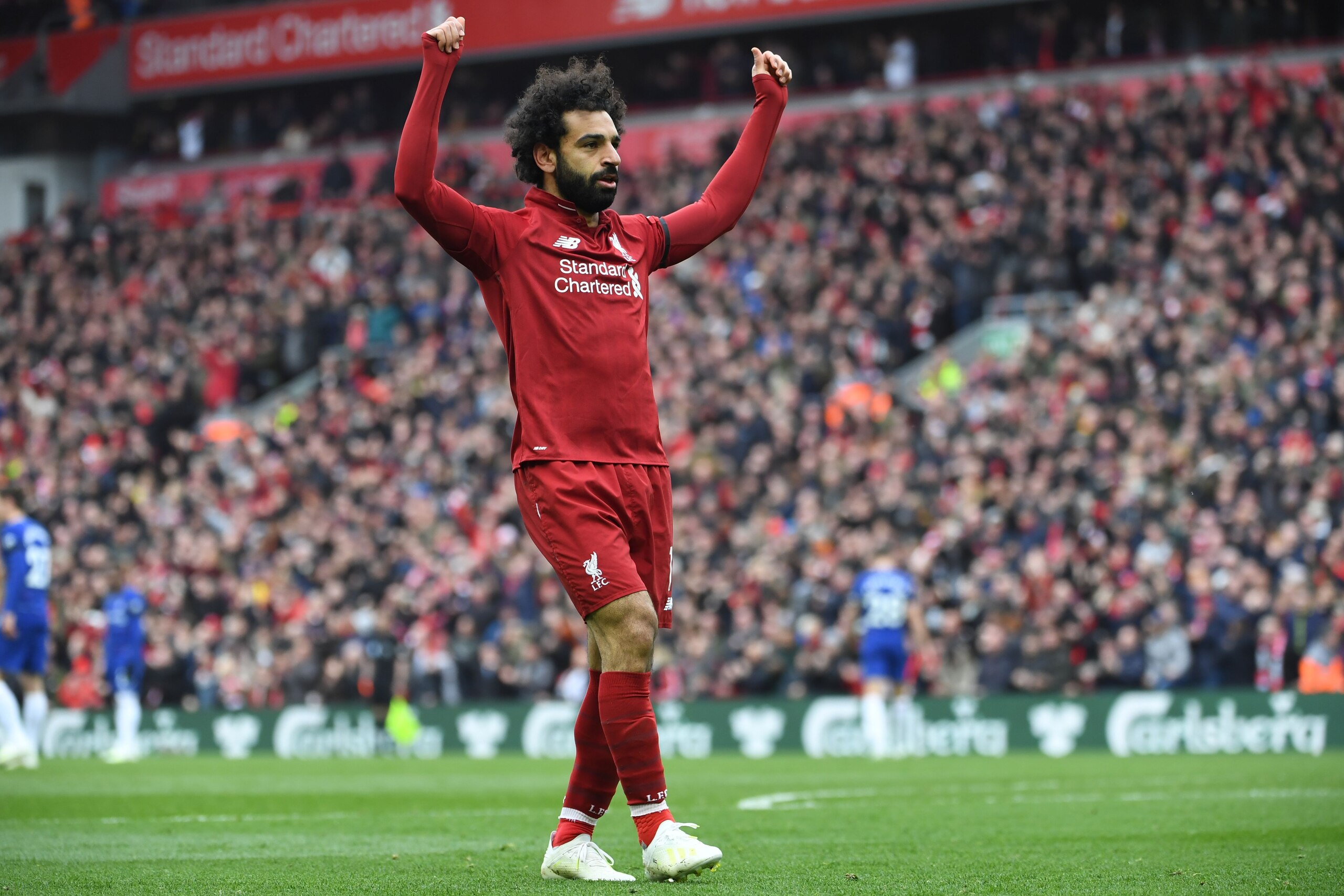 Liverpool's Egyptian midfielder Mohamed Salah celebrates after scoring their second goal during the English Premier League football match between Liverpool and Chelsea at Anfield in Liverpool, north west England on April 14, 2019. (Photo by Paul ELLIS / A