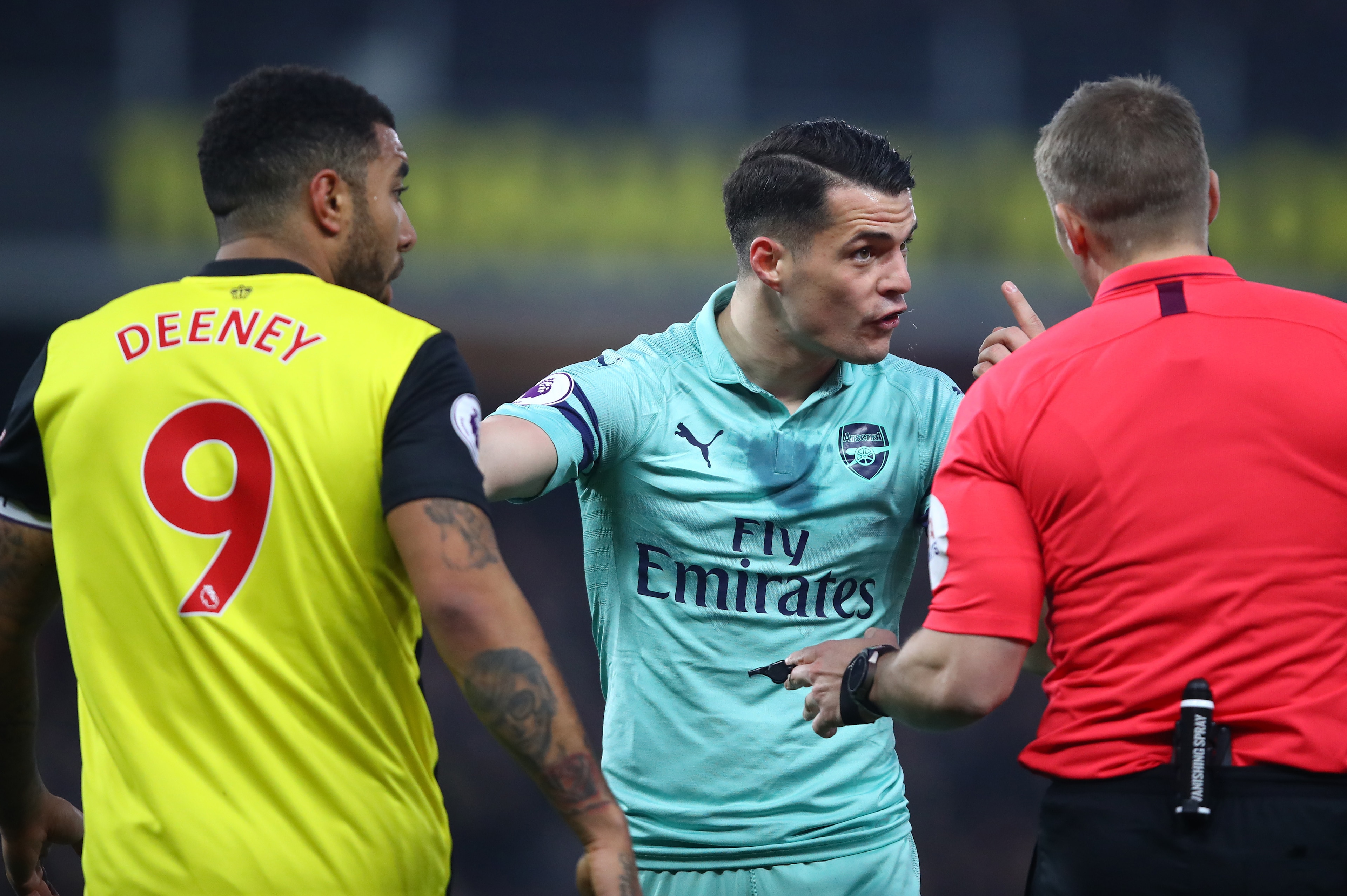 WATFORD, ENGLAND - APRIL 15:  Granit Xhaka of Arsenal remonstrates with Referee, Craig Pawson after Troy Deeney of Watford elbowed Lucas Torreira of Arsenal during the Premier League match between Watford FC and Arsenal FC at Vicarage Road on April 15, 20