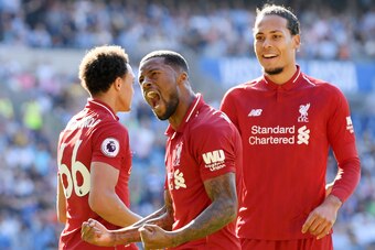 CARDIFF, WALES - APRIL 21:  Georginio Wijnaldum of Liverpool (front) celebrates as he scores his team's first goal during the Premier League match between Cardiff City and Liverpool FC at Cardiff City Stadium on April 21, 2019 in Cardiff, United Kingdom. 