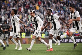 (From L) Juventus' Colombian midfielder Juan Cuadrado, Juventus' Portuguese forward Cristiano Ronaldo, Juventus' French midfielder Blaise Matuidi and Juventus' German midfielder Emre Can celebrate after Juventus secured its 8th consecutive Italian 2018/19