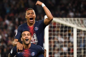 Paris Saint-Germain's Brazilian defender Dani Alves (bot) and Paris Saint-Germain's French forward Kylian Mbappe celebrate after scoring a third goal during the French L1 football match between Paris Saint-Germain (PSG) and Monaco (ASM) on April 21, 2019 