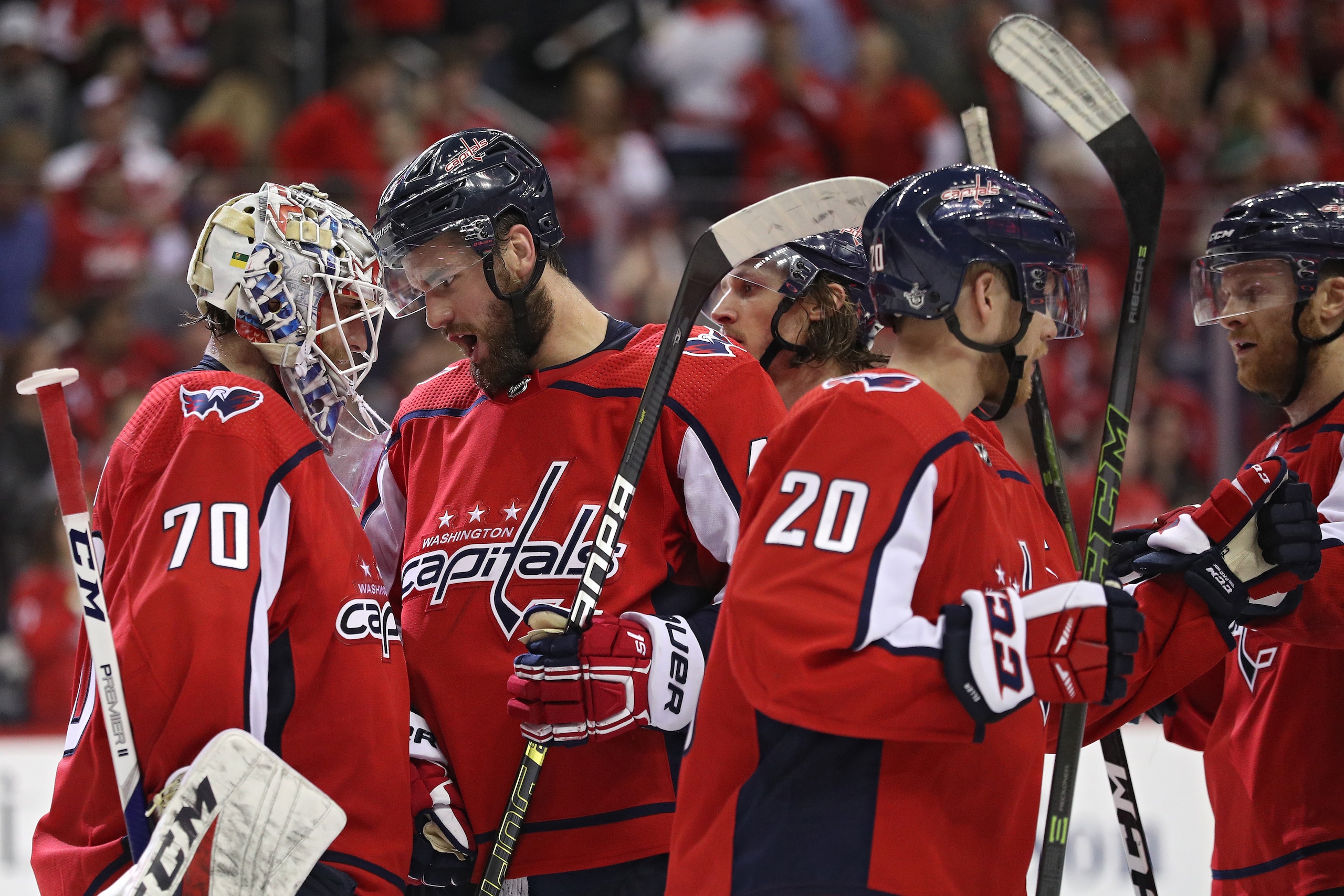 WASHINGTON, DC - APRIL 20: Braden Holtby #70 and Tom Wilson #43 of the Washington Capitals celebrate after defeating the Carolina Hurricanes in Game Five of the Eastern Conference First Round during the 2019 NHL Stanley Cup Playoffs at Capital One Arena o