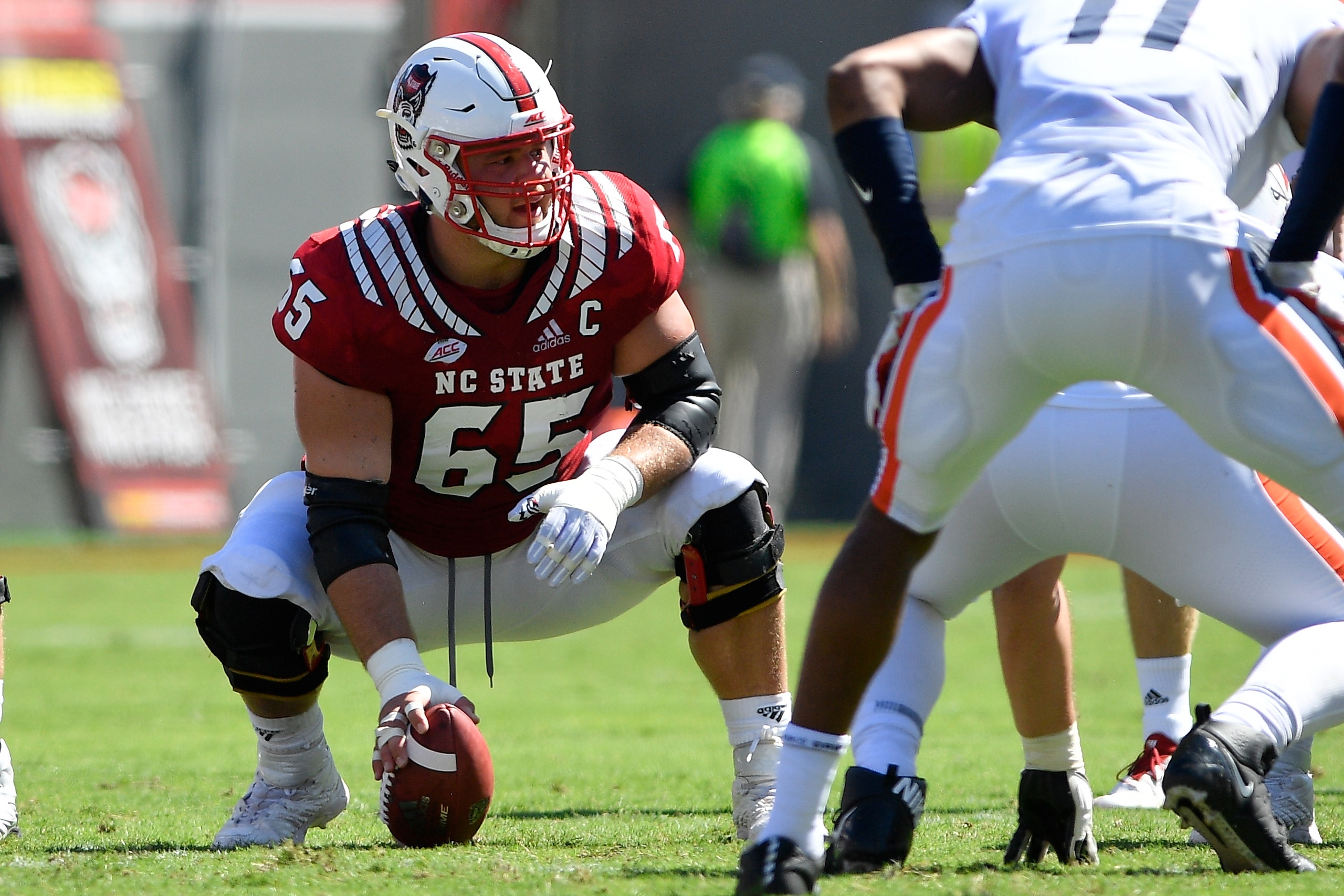 RALEIGH, NC - SEPTEMBER 29: Garrett Bradbury #65 of the North Carolina State Wolfpack prepares to snap the ball against the Virginia Cavaliers at Carter-Finley Stadium on September 29, 2018 in Raleigh, North Carolina. NC State won 35-21. (Photo by Lance K