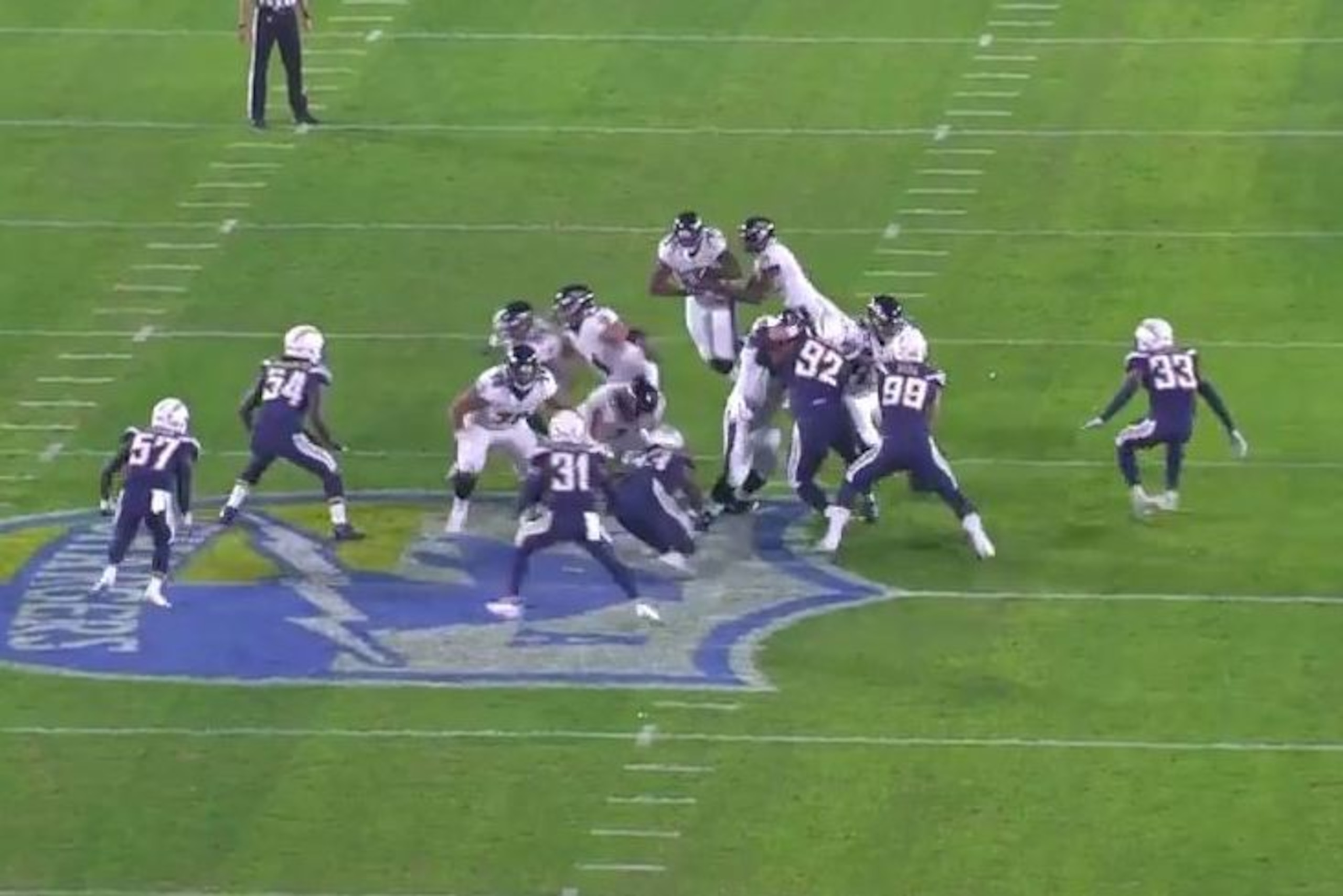 Baltimore Ravens quarterback Lamar Jackson hands the ball to running back Gus Edwards in a Week 15 contest against the Los Angeles Chargers.