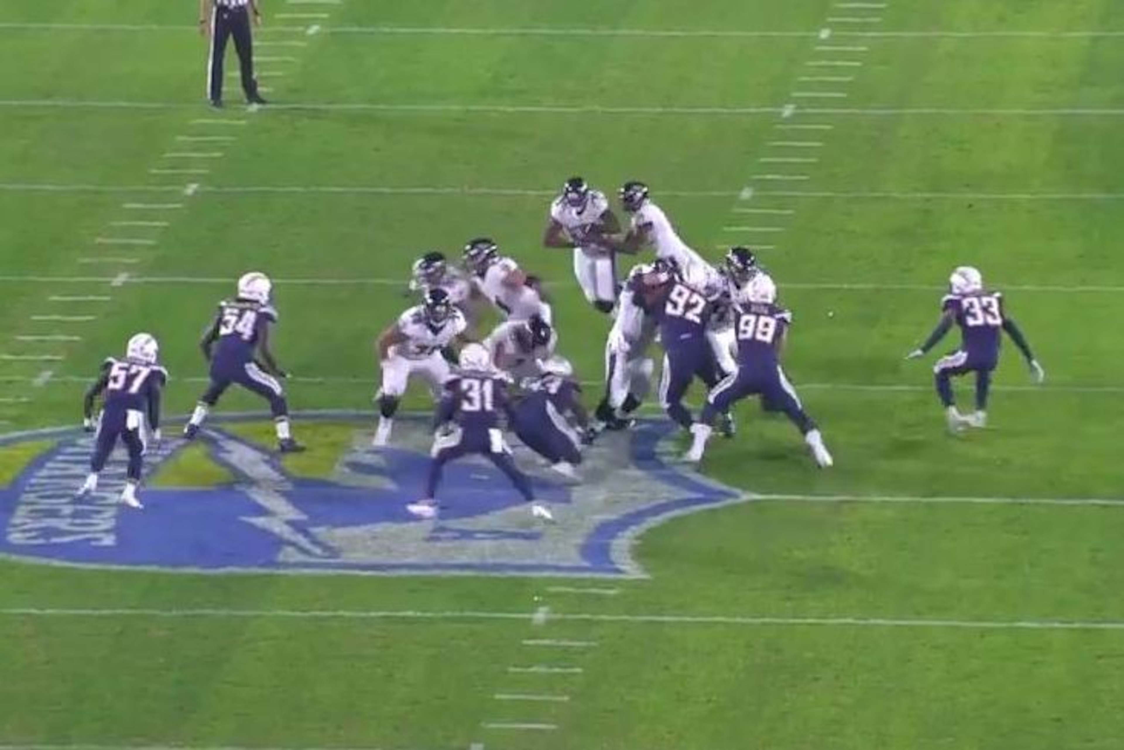 Baltimore Ravens quarterback Lamar Jackson hands the ball to running back Gus Edwards in a Week 15 contest against the Los Angeles Chargers.