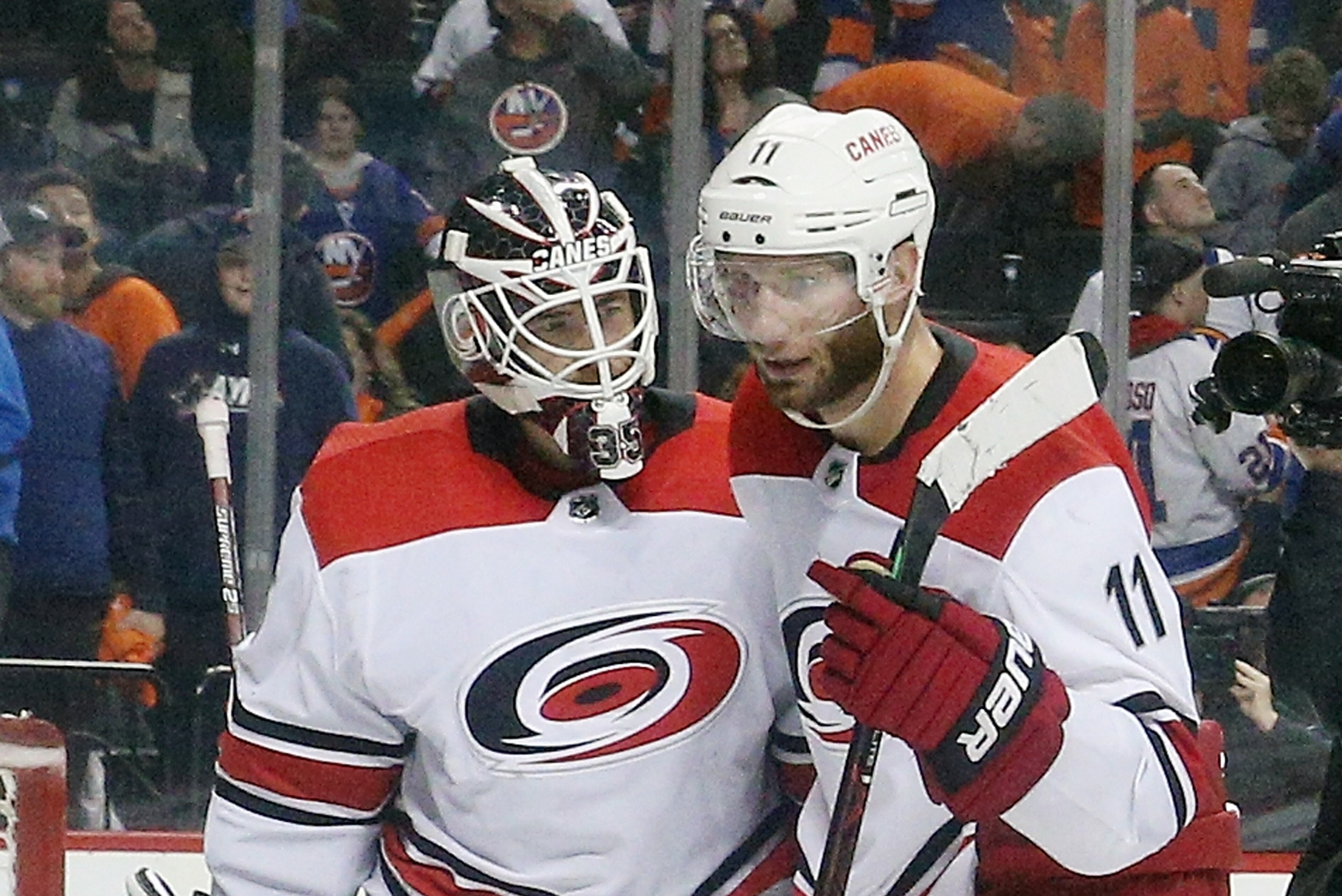NEW YORK, NEW YORK - APRIL 28:Curtis McElhinney #35 and Jordan Staal #11 of the Carolina Hurricanes celebrate their 2-1 victory over the New York Islanders in Game Two of the Eastern Conference Second Round during the 2019 NHL Stanley Cup Playoffs at the NEW YORK, NEW YORK - APRIL 28:Curtis McElhinney #35 and Jordan Staal #11 of the Carolina Hurricanes celebrate their 2-1 victory over the New York Islanders in Game Two of the Eastern Conference Second Round during the 2019 NHL Stanley Cup Playoffs at the
