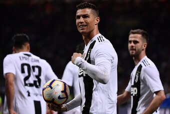 Juventus' Portuguese forward Cristiano Ronaldo (C) celebrates after scoring a goal during the Italian Serie A football match between Inter Milan and Juventus on April 27, 2019 at the San Siro stadium in Milan. (Photo by MARCO BERTORELLO / AFP)        (Pho