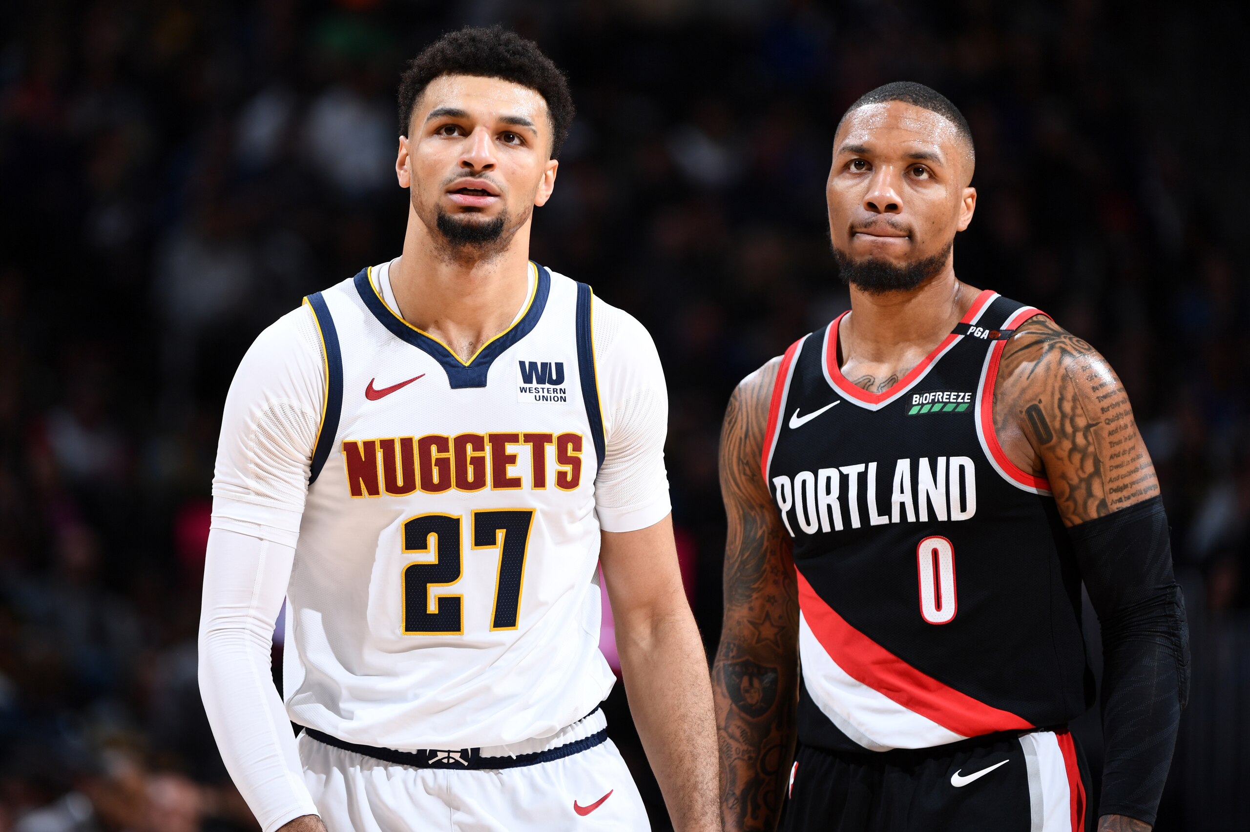 DENVER, CO - APRIL 29: Jamal Murray #27 of the Denver Nuggets and Damian Lillard #0 of the Portland Trail Blazers look on during Game One of the Western Conference Semifinals of the 2019 NBA Playoffs on April 29, 2019 at the Pepsi Center in Denver, Colora