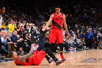 DENVER, CO - MAY 1: CJ McCollum #3 helps up Damian Lillard #0 of the Portland Trail Blazers against the Denver Nuggets during Game Two of the Western Conference Semifinals of the 2019 NBA Playoffs on May 1, 2019 at the Pepsi Center in Denver, Colorado. NO