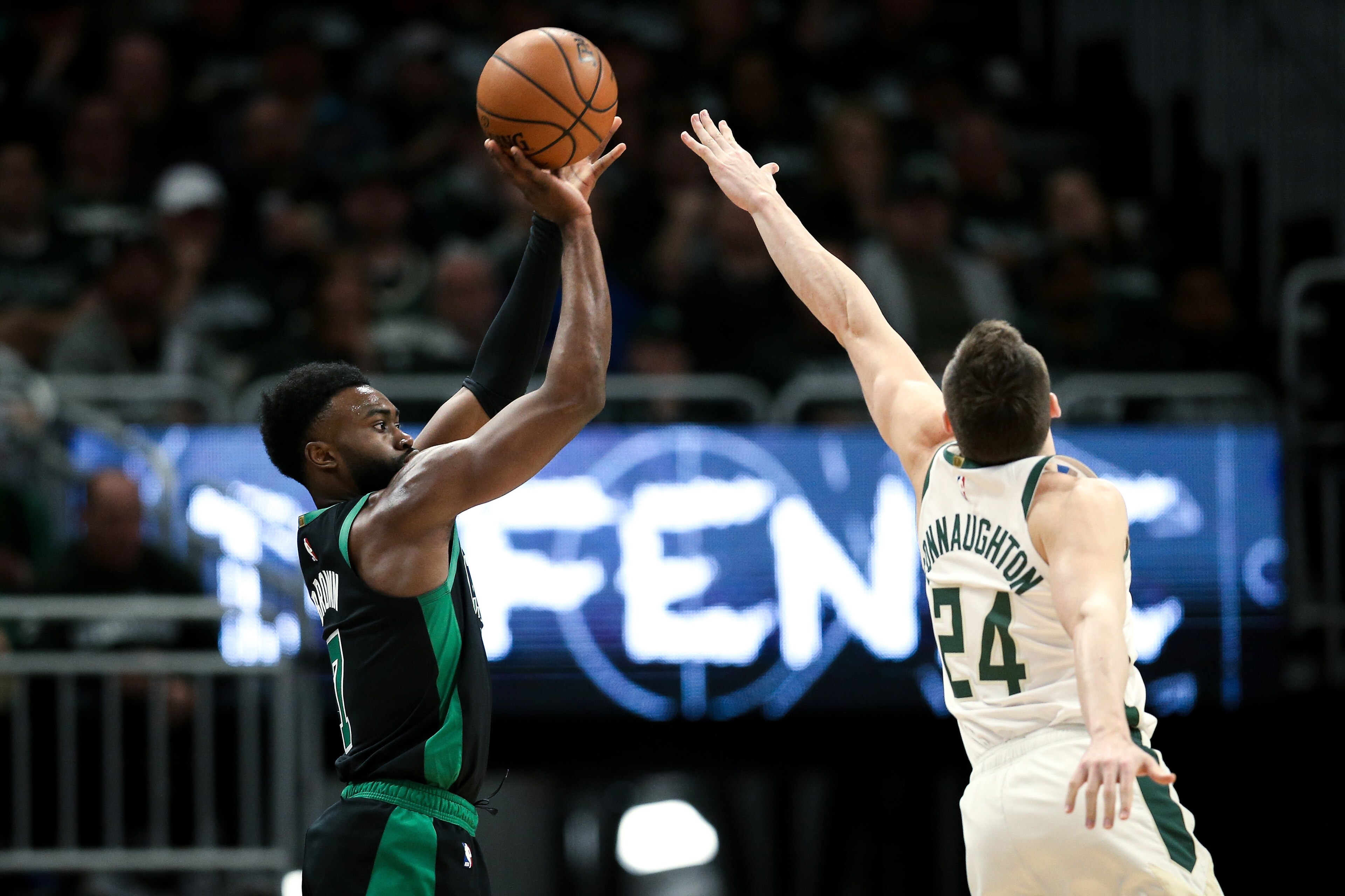 MILWAUKEE, WISCONSIN - APRIL 28:  Jaylen Brown #7 of the Boston Celtics attempts a shot while being guarded by Pat Connaughton #24 of the Milwaukee Bucks in the fourth quarter during Game One of Round Two of the 2019 NBA Playoffs at the Fiserv Forum on Ap