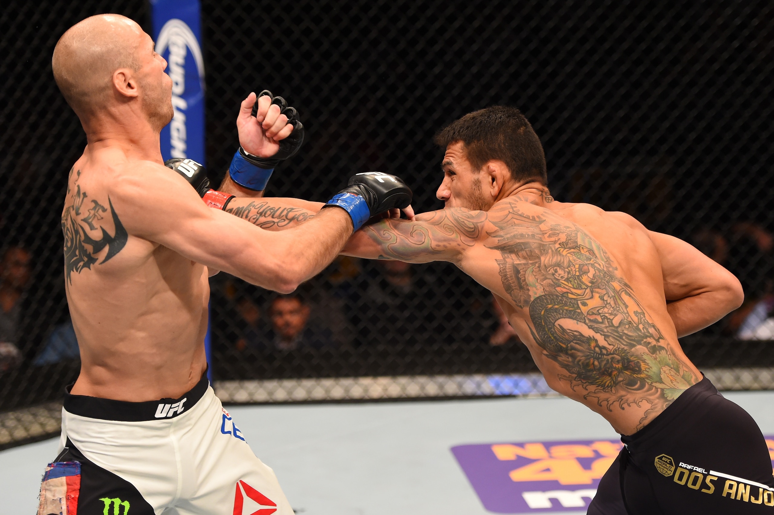ORLANDO, FL - DECEMBER 19:   (R-L) Rafael dos Anjos punches Donald Cerrone in their UFC lightweight title bout during the UFC Fight Night event at the Amway Center on December 19, 2015 in Orlando, Florida. (Photo by Josh Hedges/Zuffa LLC/Zuffa LLC via Get