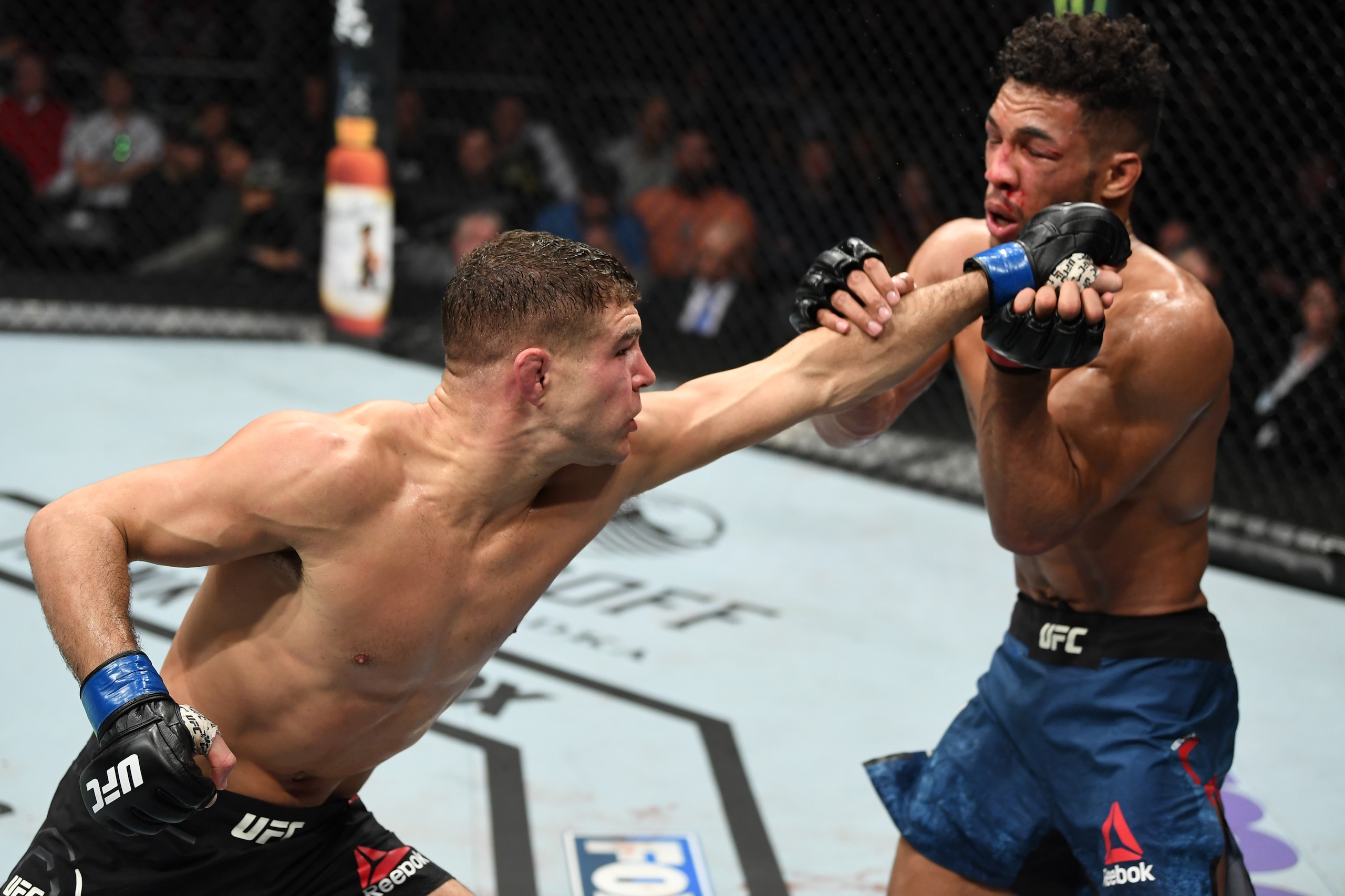 MILWAUKEE, WISCONSIN - DECEMBER 15:  (L-R) Al Iaquinta punches Kevin Lee in their lightweight bout during the UFC Fight Night event at Fiserv Forum on December 15, 2018 in Milwaukee, Wisconsin. (Photo by Jeff Bottari/Zuffa LLC/Zuffa LLC via Getty Images)