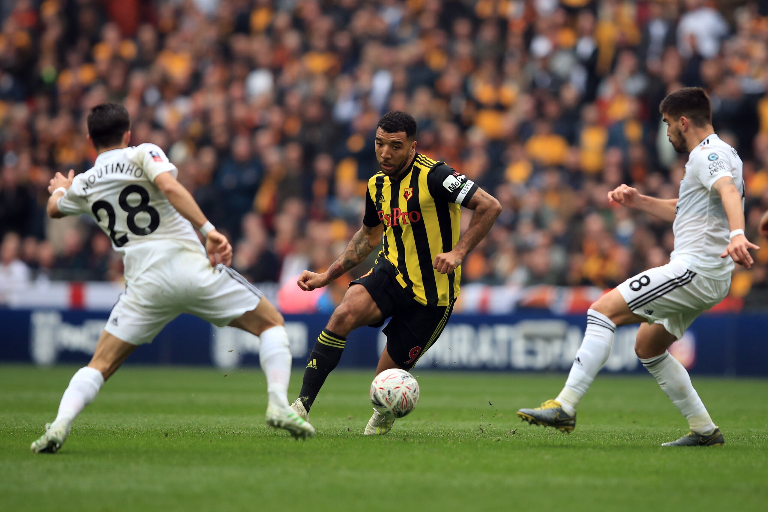 LONDON, ENGLAND - APRIL 07:  Troy Deeney of Watford in action with Joao Moutinho and Ruben Neves of Wolverhampton Wanderers  during the FA Cup Semi Final match between Watford and Wolverhampton Wanderers at Wembley Stadium on April 07, 2019 in London, Eng