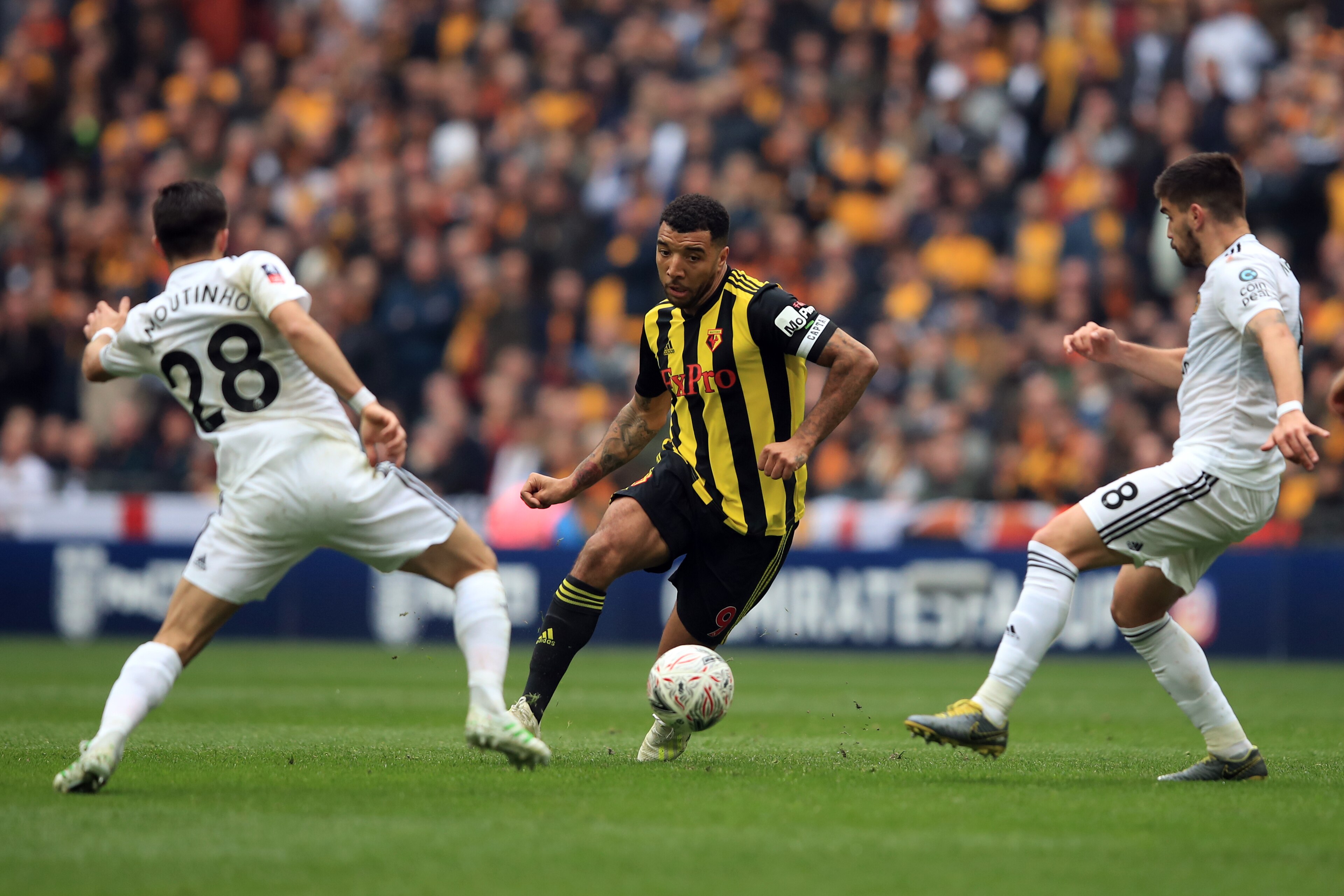 LONDON, ENGLAND - APRIL 07:  Troy Deeney of Watford in action with Joao Moutinho and Ruben Neves of Wolverhampton Wanderers  during the FA Cup Semi Final match between Watford and Wolverhampton Wanderers at Wembley Stadium on April 07, 2019 in London, Eng