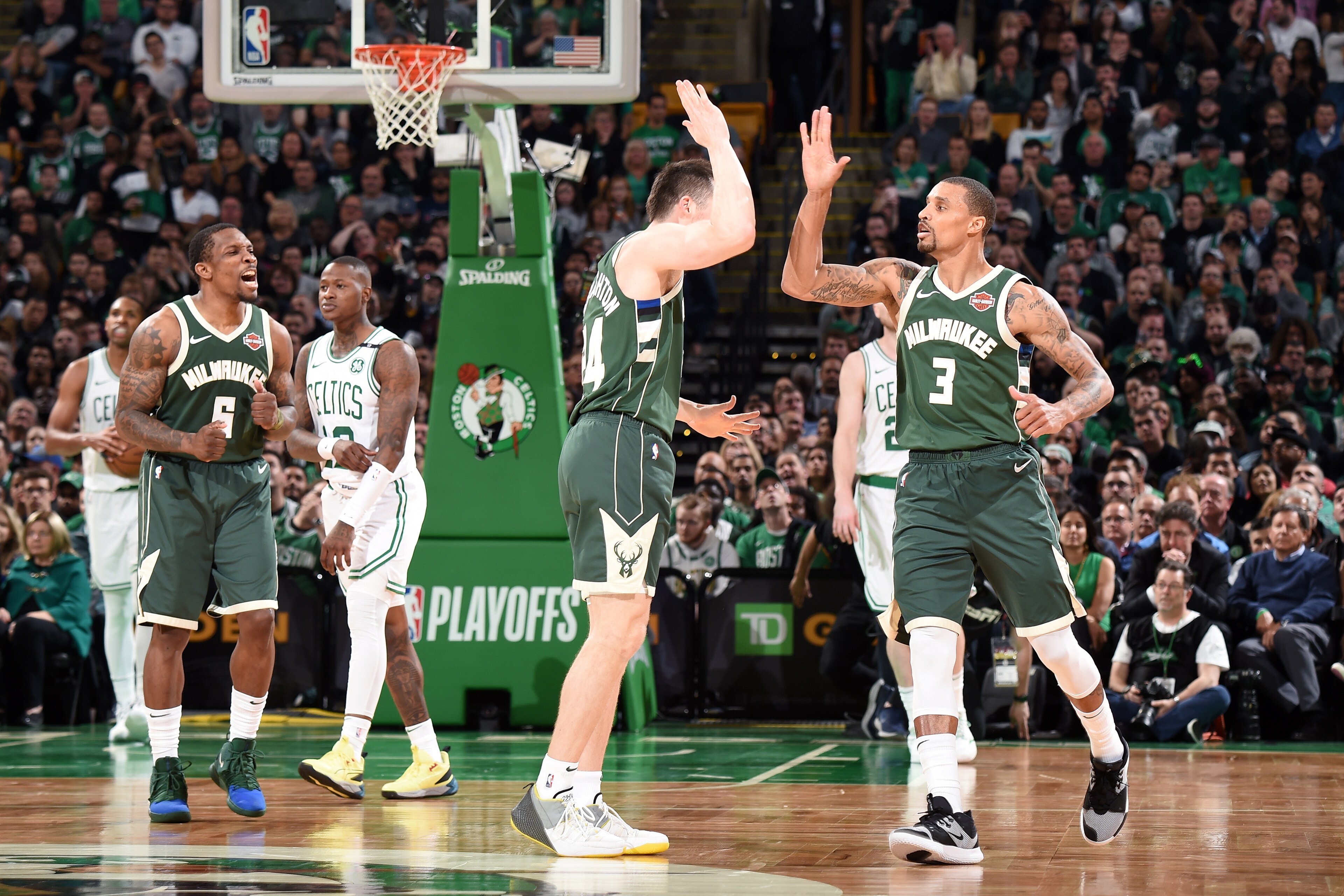 BOSTON, MA - MAY 3: Pat Connaughton #24 and George Hill #3 of the Milwaukee Bucks high five during Game Three of the Eastern Conference Semifinals of the 2019 NBA Playoffs against the Boston Celtics on May 3, 2019 at the TD Garden in Boston, Massachusetts