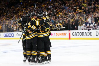 BOSTON, MASSACHUSETTS - MAY 04: Brad Marchand #63 of the Boston Bruins is surrounded by teammates after scoring a goal against the Columbus Blue Jackets during the third period of Game Five of the Eastern Conference Second Round during the 2019 NHL Stanle