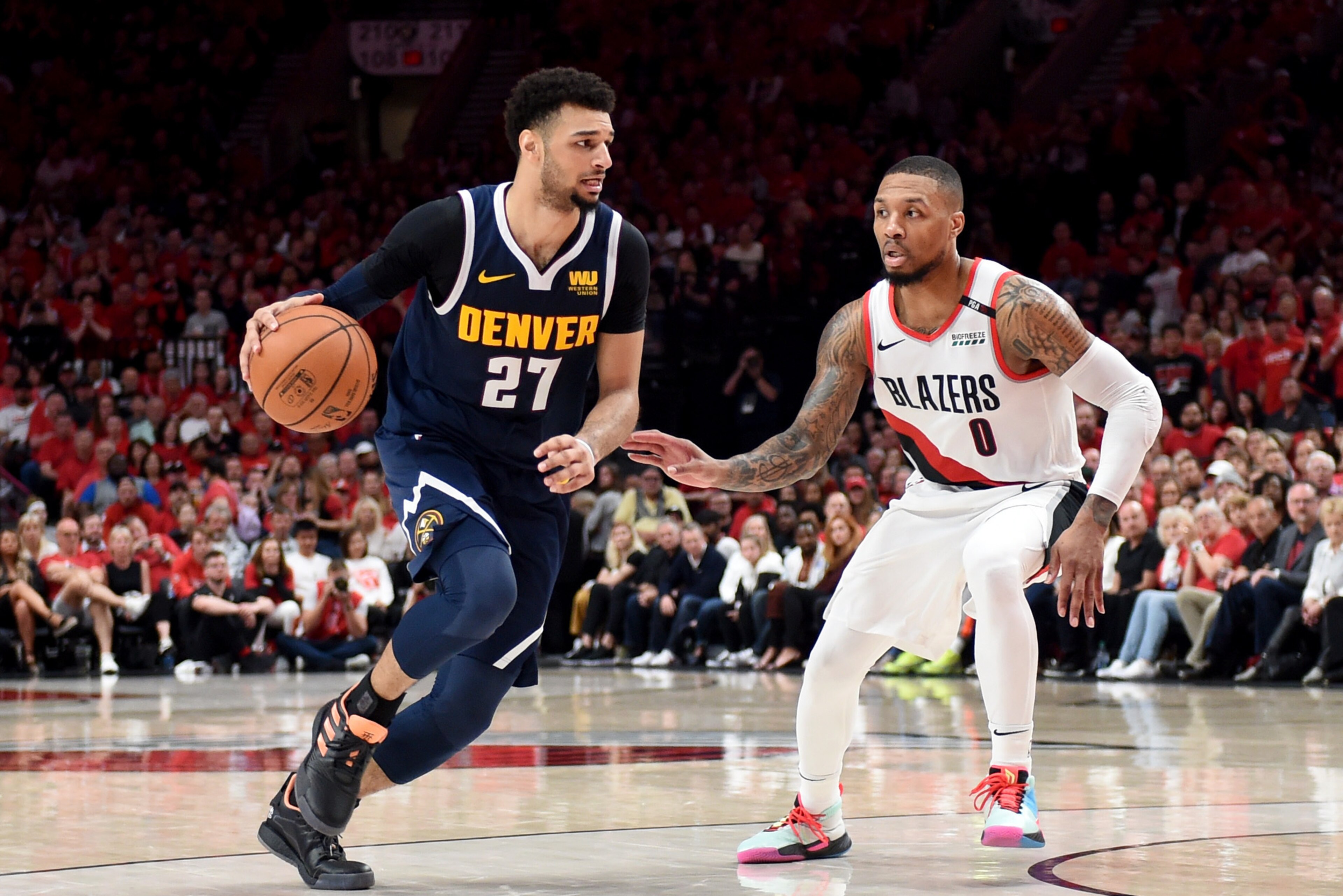 PORTLAND, OREGON - MAY 05: Jamal Murray #27 of the Denver Nuggets drives to the basket on Damian Lillard #0 of the Portland Trail Blazers during the second half of game four of the Western Conference Semifinals at Moda Center on May 05, 2019 in Portland, 