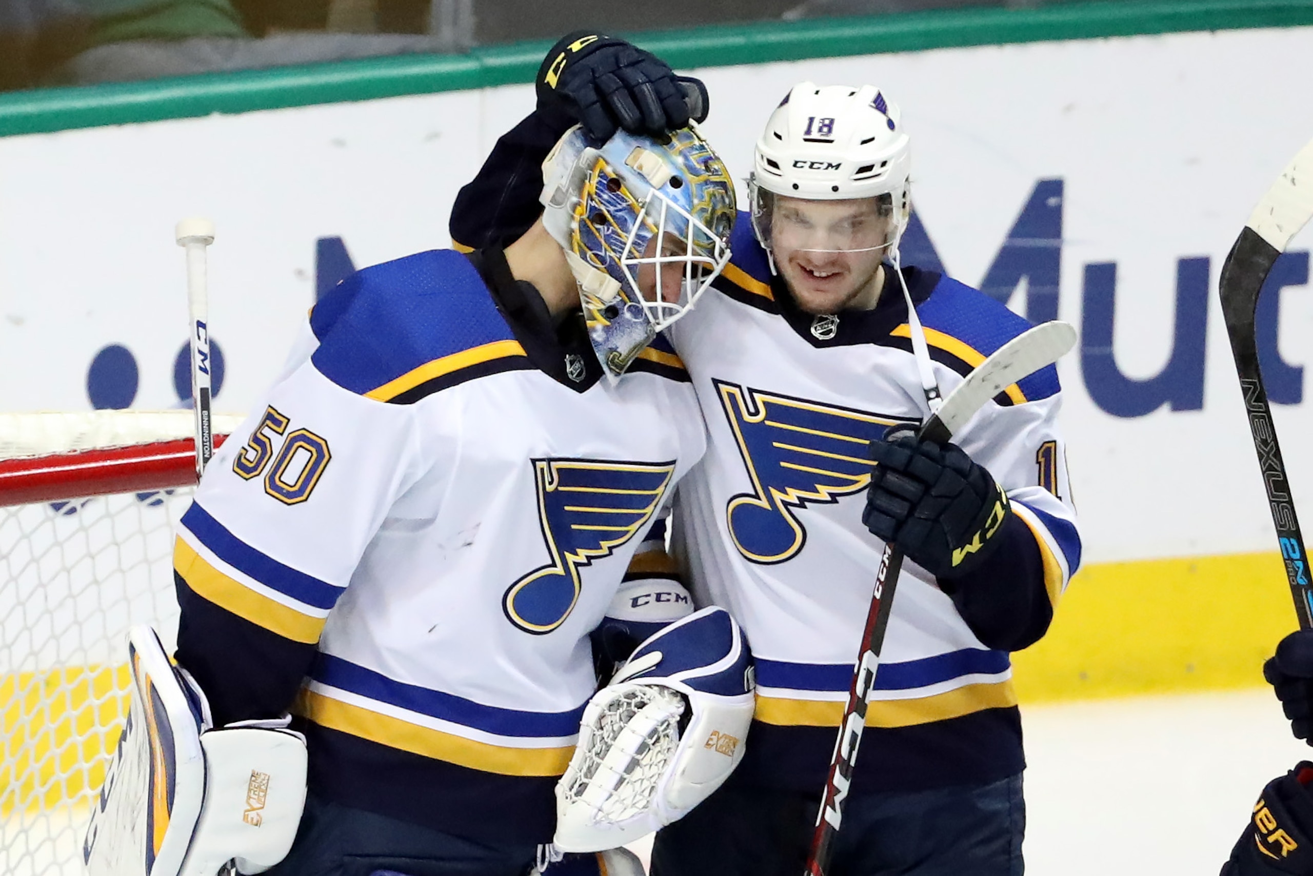 DALLAS, TEXAS - MAY 05:  Jordan Binnington #50 of the St. Louis Blues and Robert Thomas #18 celebrate a 4-1 win against the Dallas Stars in Game Six of the Western Conference Second Round of the 2019 NHL Stanley Cup Playoffs at American Airlines Center on