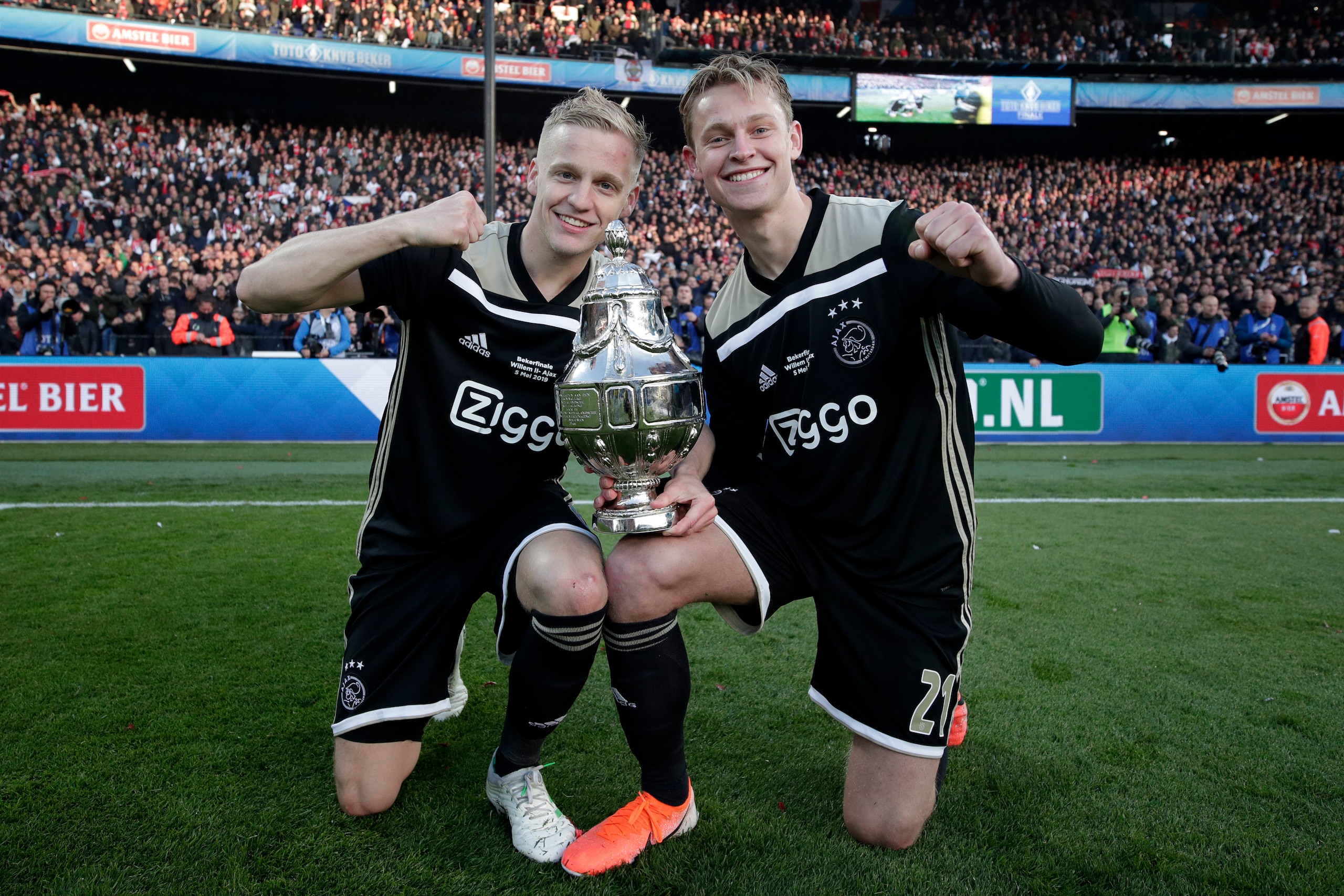 ROTTERDAM, NETHERLANDS - MAY 5: Donny van de Beek of Ajax, Frenkie de Jong of Ajax celebrates the championship with the trophy during the Dutch KNVB Beker match between Willem II v Ajax Dutch Toto KNVB Cup Final at the Feyenoord Stadium on May 5, 2019 i ROTTERDAM, NETHERLANDS - MAY 5: Donny van de Beek of Ajax, Frenkie de Jong of Ajax celebrates the championship with the trophy during the Dutch KNVB Beker match between Willem II v Ajax Dutch Toto KNVB Cup Final at the Feyenoord Stadium on May 5, 2019 i