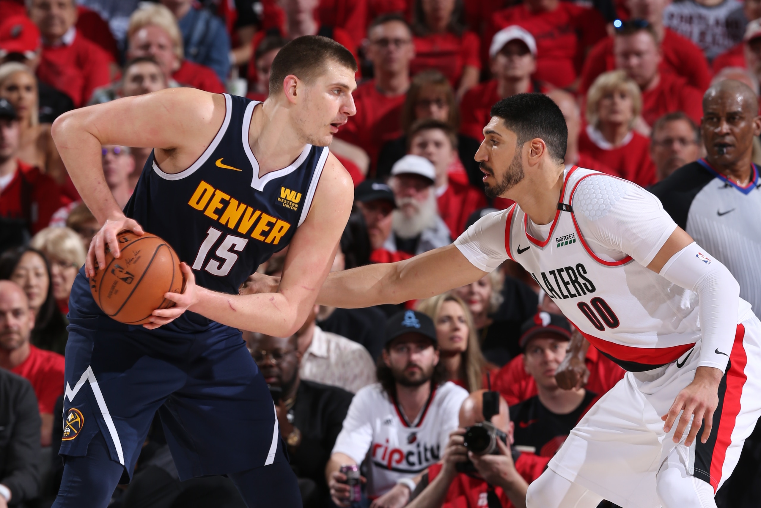 PORTLAND, OR - MAY 5: Nikola Jokic #15 of the Denver Nuggets handles the ball against Enes Kanter #00 of the Portland Trail Blazers during Game Four of the Western Conference Semifinals of the 2019 NBA Playoffs on May 5, 2019 at the Moda Center Arena in P
