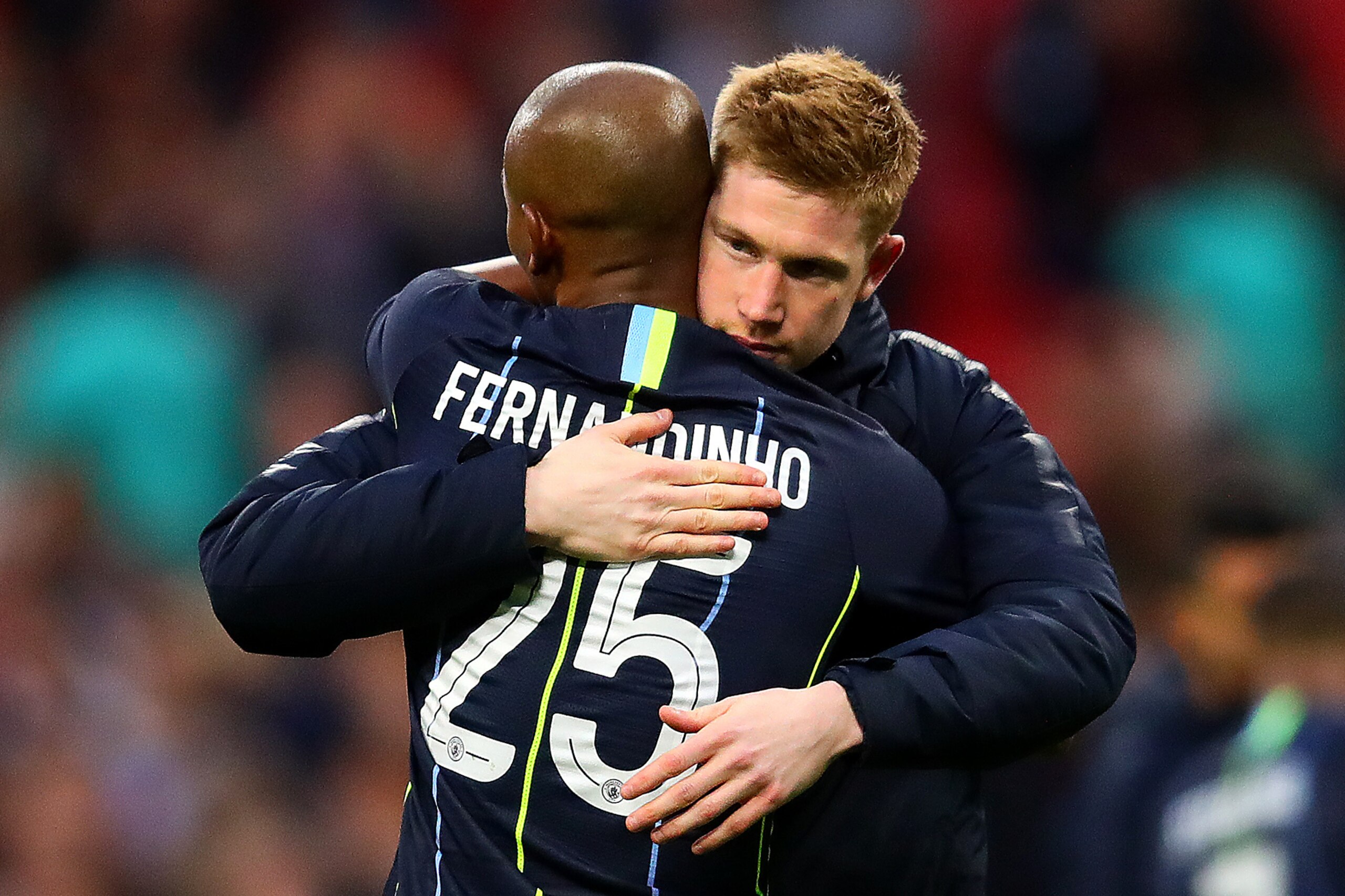 LONDON, ENGLAND - APRIL 06: Kevin De Bruyne of Manchester City embraces team-mate Fernandinho at full-time following the FA Cup Semi Final match between Manchester City  and Brighton and Hove Albion at Wembley Stadium on April 06, 2019 in London, England.