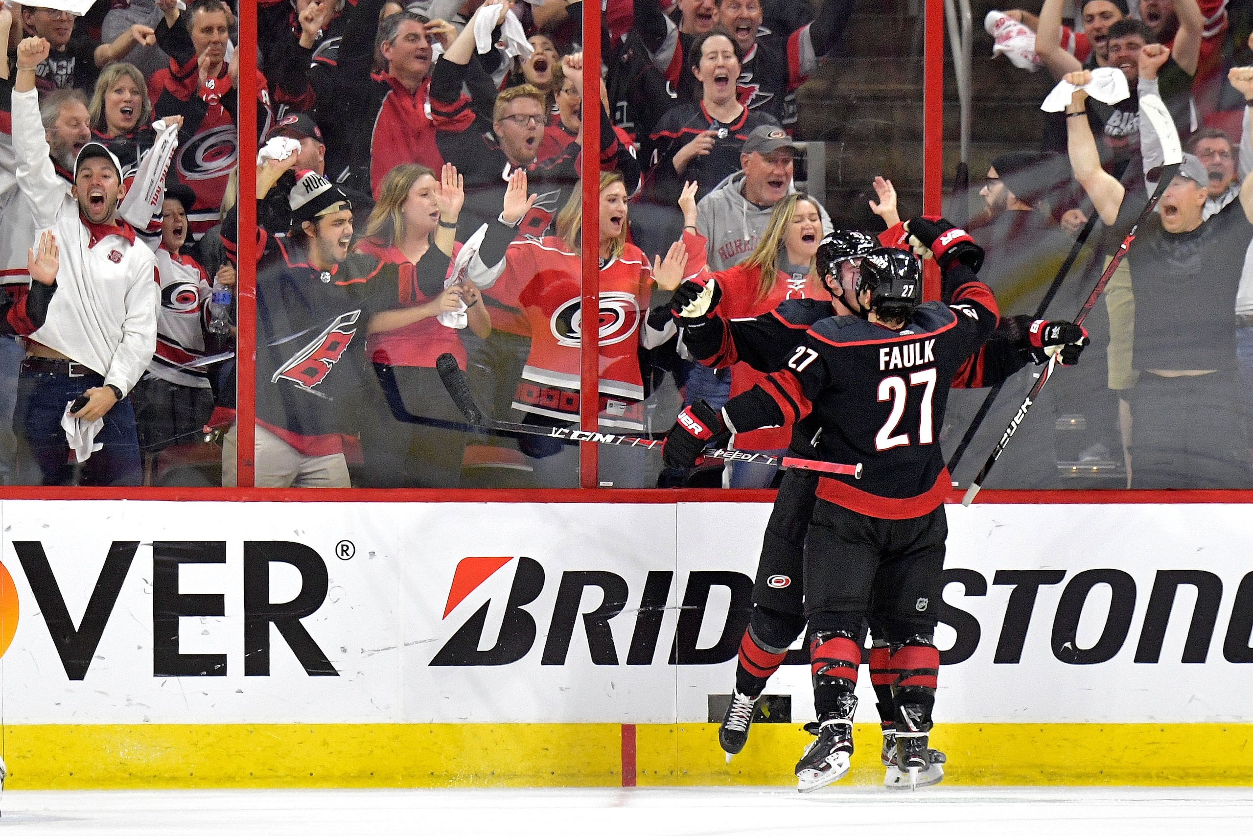 RALEIGH, NORTH CAROLINA - MAY 03: Andrei Svechnikov #37 celebrates with Justin Faulk #27 of the Carolina Hurricanes after scoring a goal against the New York Islanders in the third period of Game Four of the Eastern Conference Second Round during the 2019