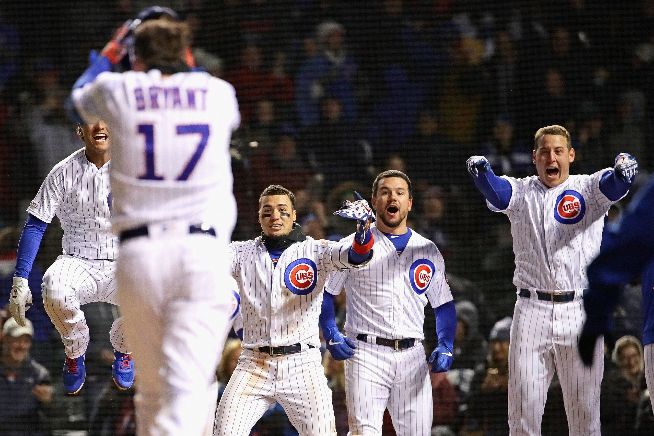 CHICAGO, ILLINOIS - MAY 07: (L-R) Albert Almora Jr #5, Javier Baez #9, s #12 and Anthony Rizzo #44 of the Chicago Cubs wait for Kris Bryant #17 to cross the plate after he hit the game-winning three run home run in the bottom of the 9th inning against the
