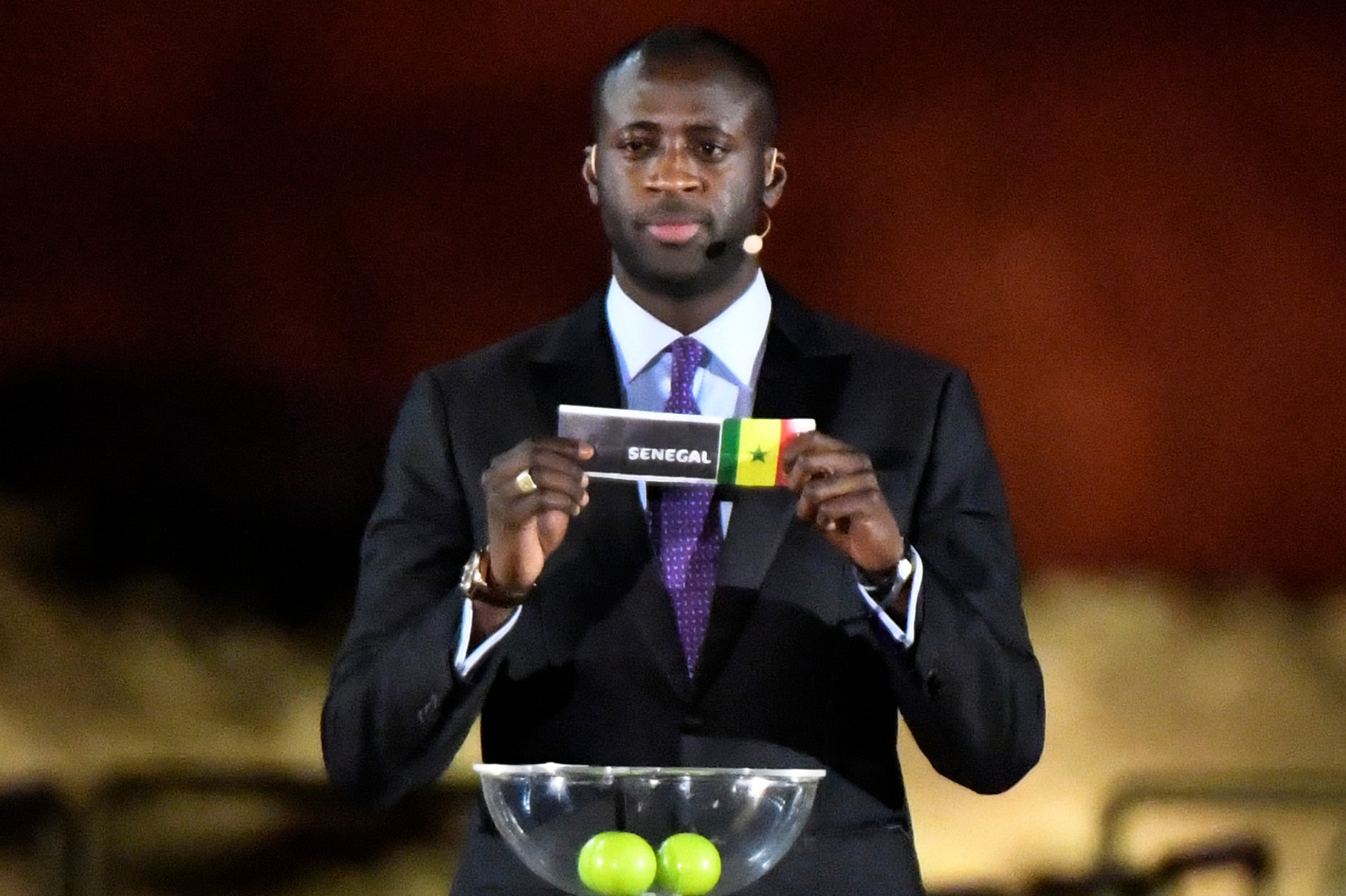 Former Ivorian midfielder Yaya Toure shows Senegal's ballot during the 2019 CAF African Cup of Nations (CAN) draw ceremony at the Giza Pyramids Necropolis on the western outskirts of the Egyptian capital Cairo on April 12, 2019. (Photo by Khaled DESOUKI /