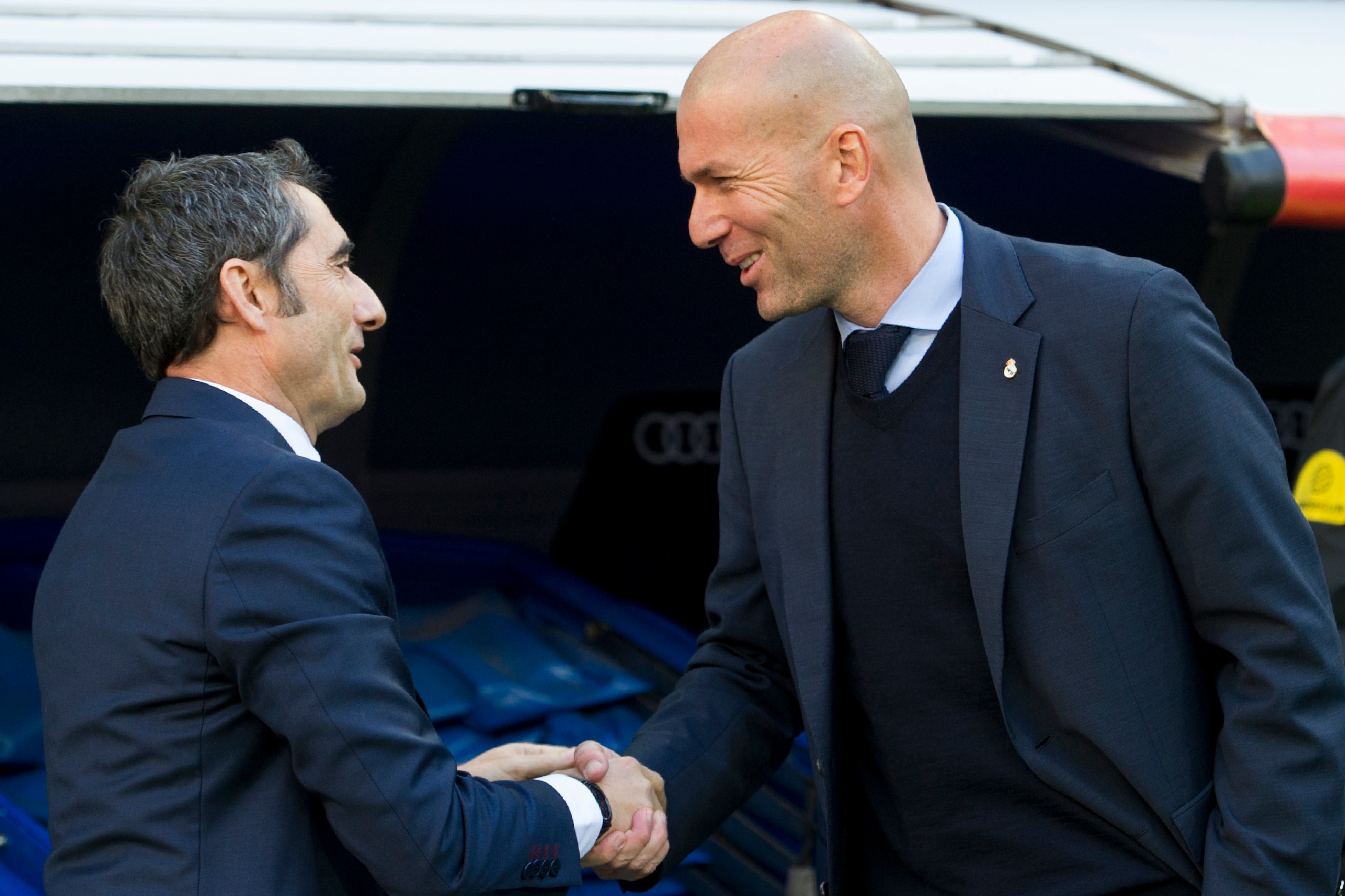 Barcelona's Spanish coach Ernesto Valverde (L) shakes hands with Real Madrid's French coach Zinedine Zidane before the Spanish League