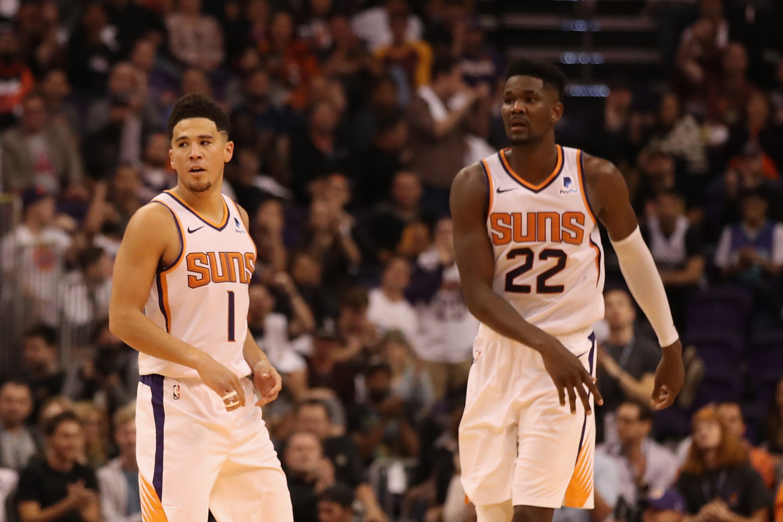 PHOENIX, AZ - OCTOBER 17:  Devin Booker #1 and Deandre Ayton #22 of the Phoenix Suns during the NBA game against the Dallas Mavericks at Talking Stick Resort Arena on October 17, 2018 in Phoenix, Arizona. The Suns defeated defeated the Mavericks 121-100. 