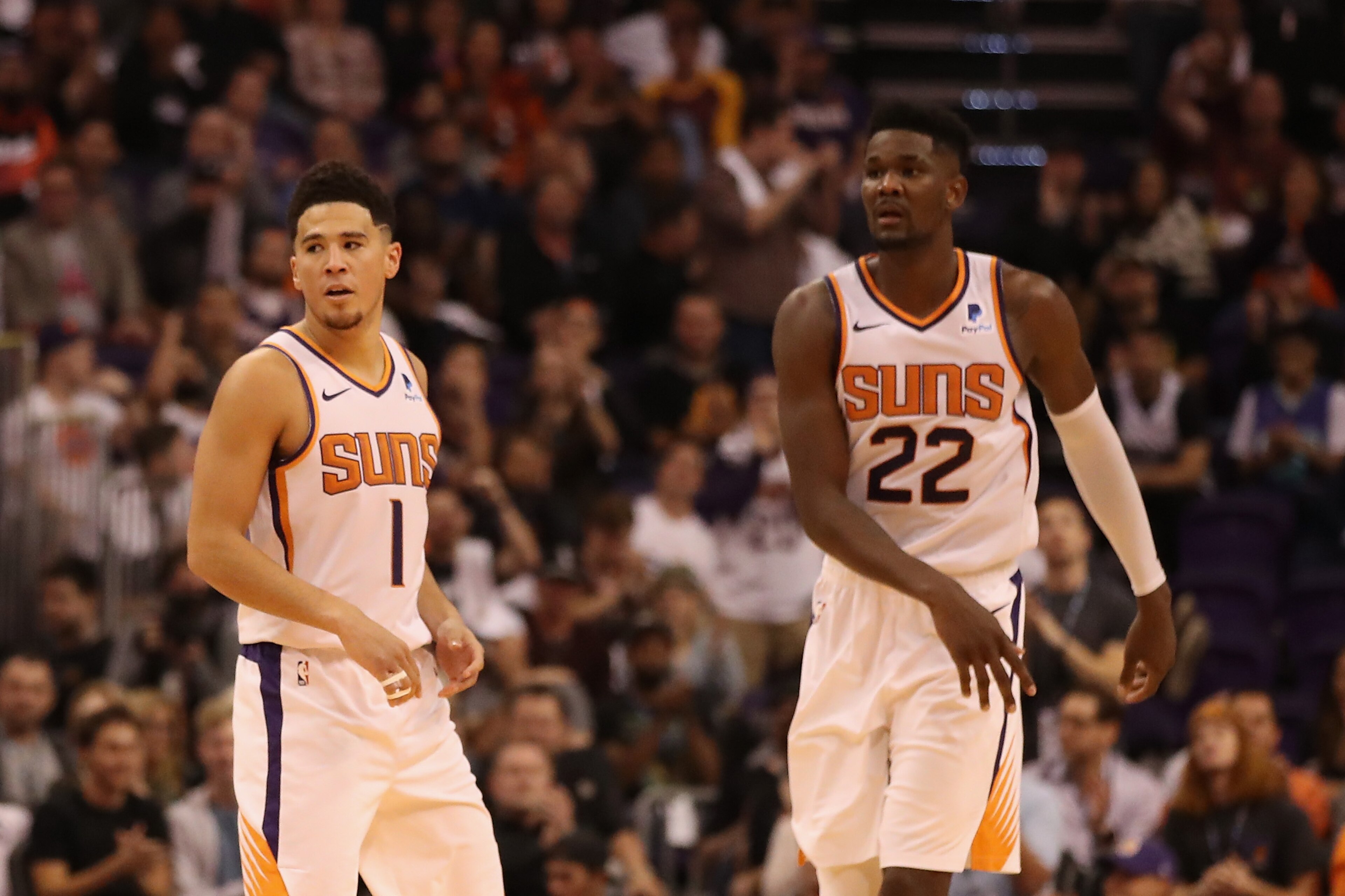 PHOENIX, AZ - OCTOBER 17:  Devin Booker #1 and Deandre Ayton #22 of the Phoenix Suns during the NBA game against the Dallas Mavericks at Talking Stick Resort Arena on October 17, 2018 in Phoenix, Arizona. The Suns defeated defeated the Mavericks 121-100. 