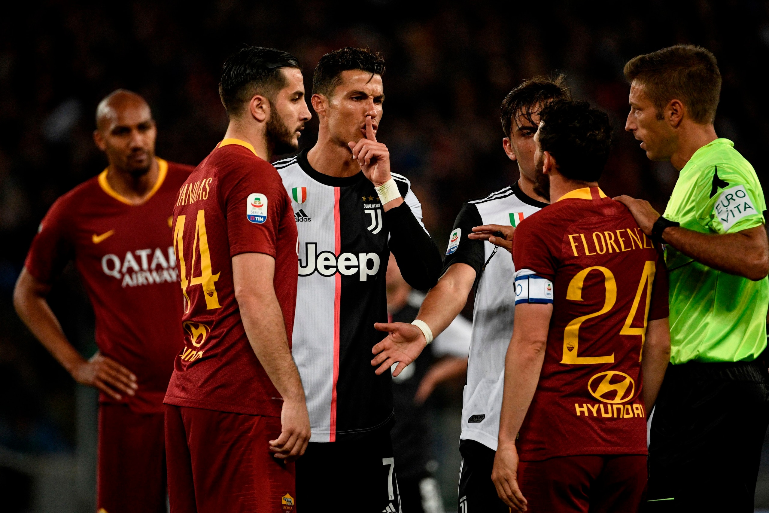 Juventus' Portuguese forward Cristiano Ronaldo (C) gestures next to AS Roma Greek defender Konstantinos Manolas (L) and AS Roma Italian midfielder Alessandro Florenzi (2R) during the Italian Serie A football match between AS Roma and Juventus Turin at the