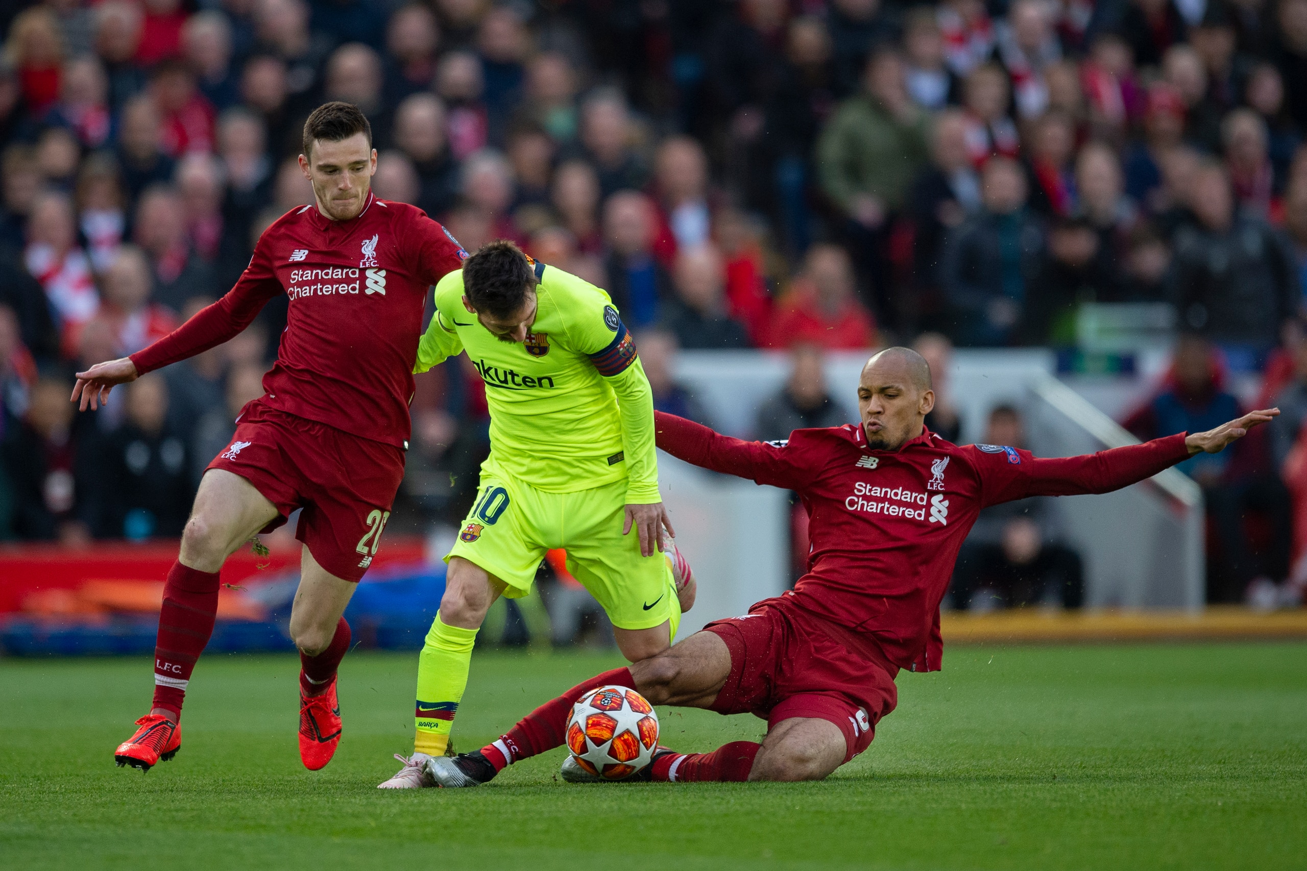 LIVERPOOL, ENGLAND - MAY 07: Lionel Messi of Barcelona takes on Andy Robertson and Fabinho of Liverpool during the UEFA Champions League Semi Final second leg match between Liverpool and Barcelona at Anfield on May 7, 2019 in Liverpool, England. (Photo by