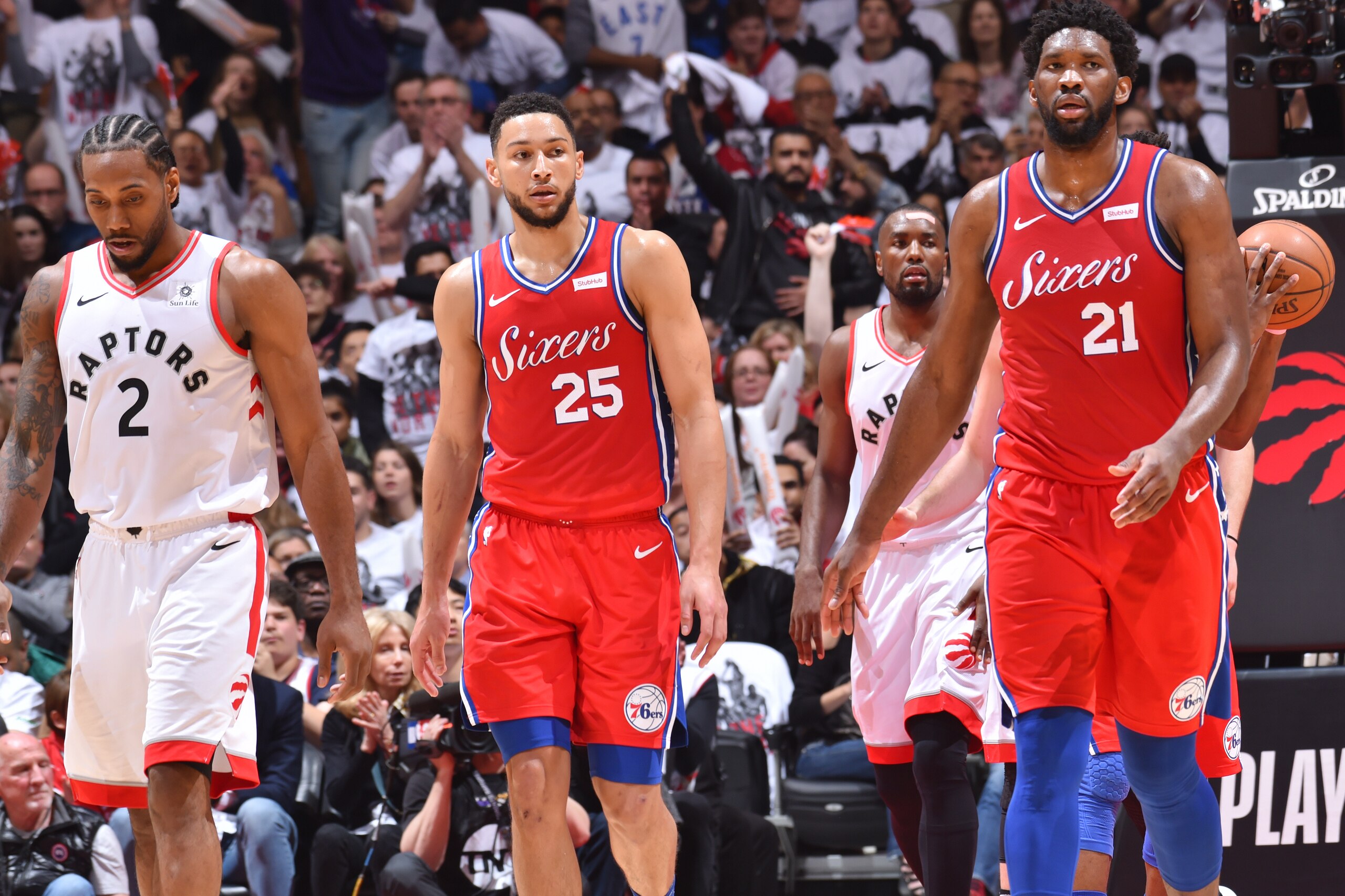 TORONTO, CANADA - MAY 12: Ben Simmons #25 and Joel Embiid #21 of the Philadelphia 76ers look on against the Toronto Raptors during Game Seven of the Eastern Conference Semi-Finals of the 2019 NBA Playoffs on May 12, 2019 at the Scotiabank Arena in Toronto