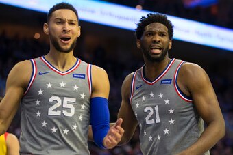 PHILADELPHIA, PA - APRIL 04: Ben Simmons #25 and Joel Embiid #21 of the Philadelphia 76ers react against the Milwaukee Bucks in the third quarter at the Wells Fargo Center on April 4, 2019 in Philadelphia, Pennsylvania. The Bucks defeated the 76ers 128-12