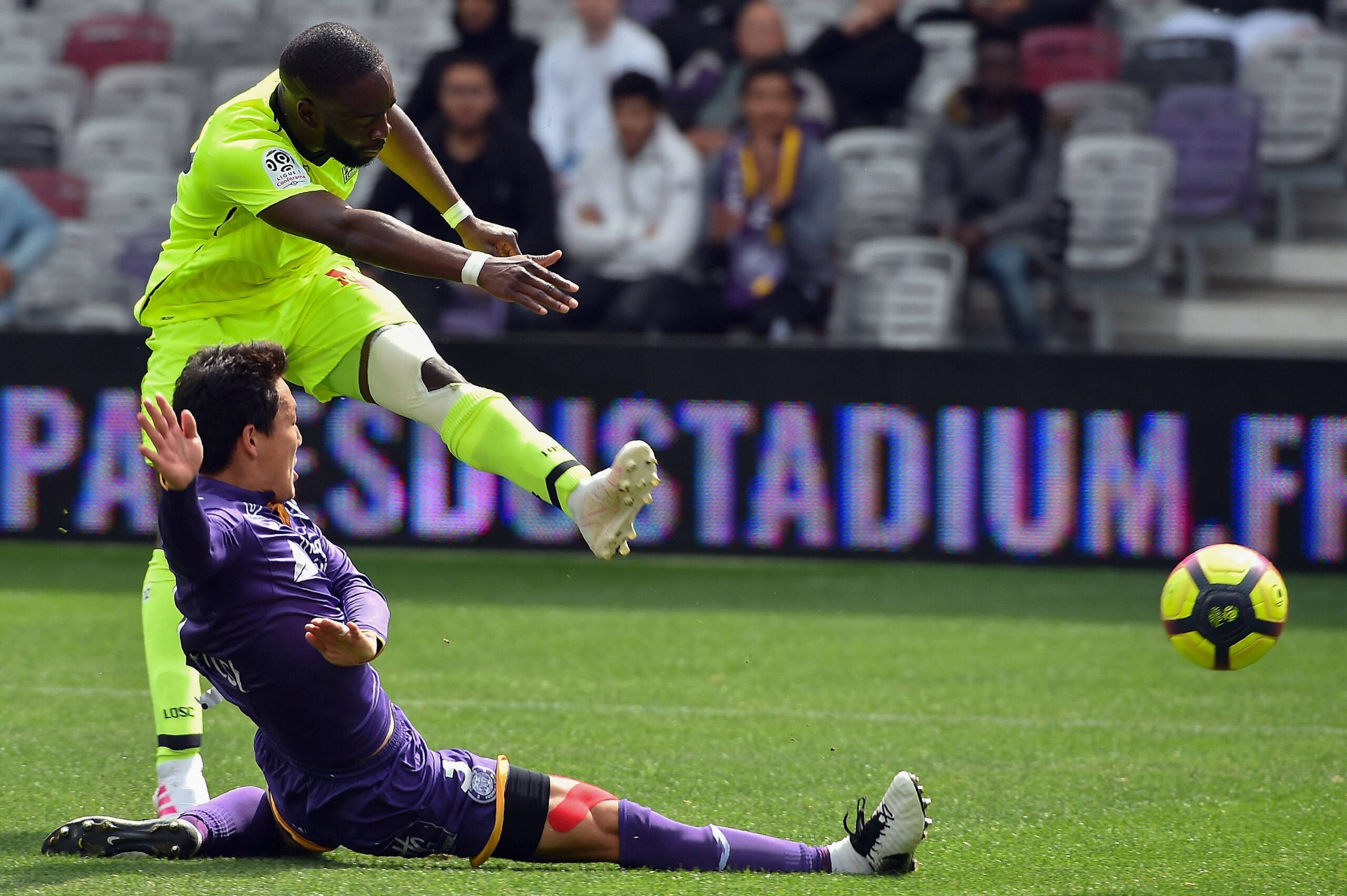 Toulouse's Japanese defender Gen Shoji (L) dives to tackle Lille's Ivorian forward Nicolas Pepe during the French L1 football match between Toulouse and Lille at The Municipal Stadium in Toulouse, southern France on April 21, 2019. (Photo by REMY GABALDA 