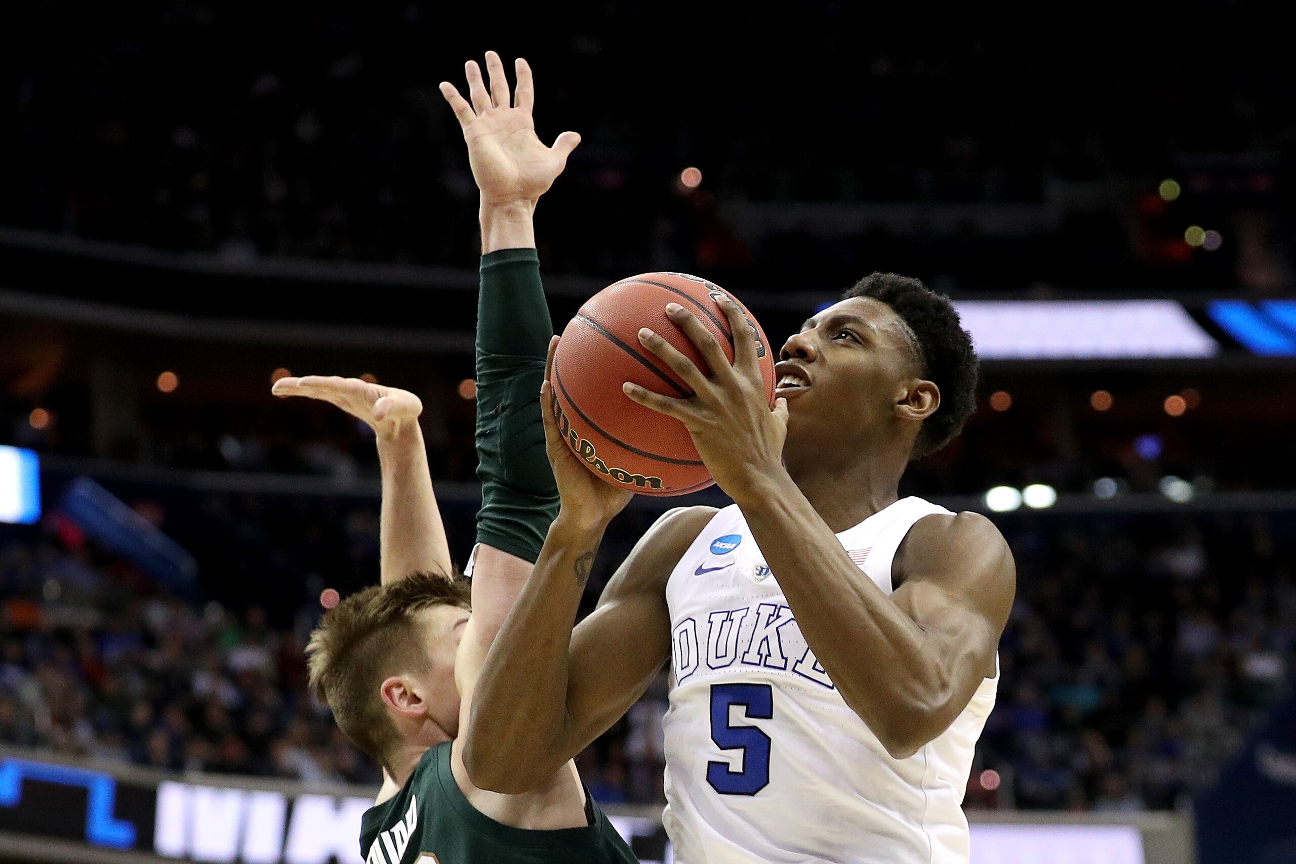 WASHINGTON, DC - MARCH 31: RJ Barrett #5 of the Duke Blue Devils attempts a shot against Matt McQuaid #20 of the Michigan State Spartans during the second half in the East Regional game of the 2019 NCAA Men's Basketball Tournament at Capital One Arena on WASHINGTON, DC - MARCH 31: RJ Barrett #5 of the Duke Blue Devils attempts a shot against Matt McQuaid #20 of the Michigan State Spartans during the second half in the East Regional game of the 2019 NCAA Men's Basketball Tournament at Capital One Arena on