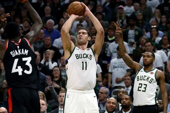 MILWAUKEE, WISCONSIN - MAY 15:  Brook Lopez #11 of the Milwaukee Bucks attempts a shot while being guarded by Pascal Siakam #43 of the Toronto Raptors in the third quarter in Game One of the Eastern Conference Finals of the 2019 NBA Playoffs at the Fiserv