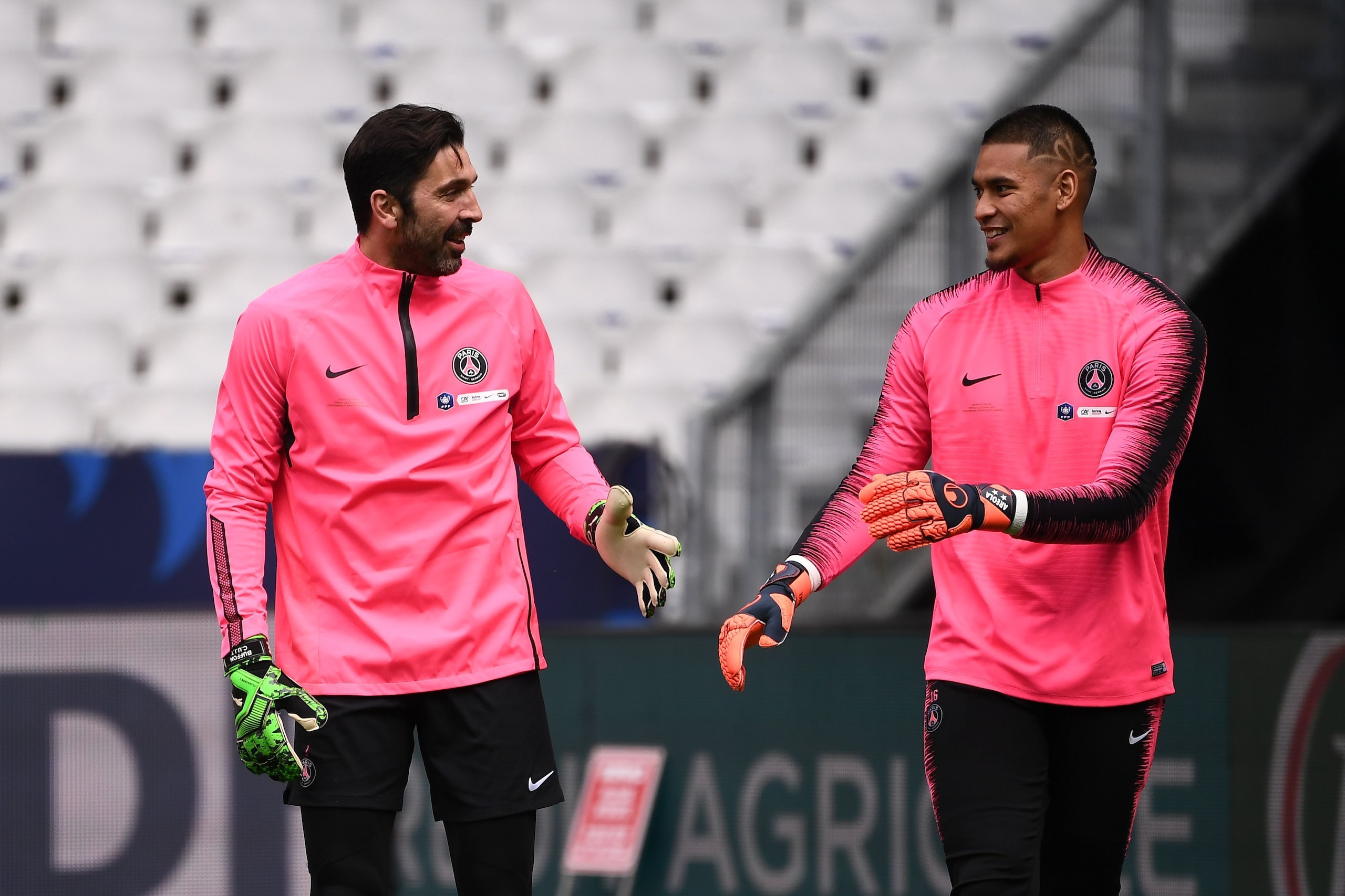 Paris Saint-Germain's Italian goalkeeper Gianluigi Buffon (L) and Paris Saint-Germain's French goalkeeper Alphonse Areola (R) attend a training session at the Stade de France, in Saint-Denis, near Paris, on April 26, 2019, on the eve of their French Cup f