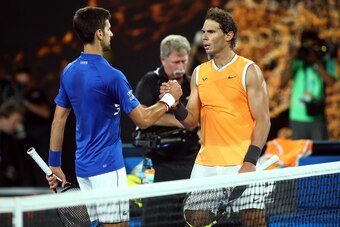 MELBOURNE, AUSTRALIA - JANUARY 27:  Novak Djokovic of Serbia is congratulated in his Men's Singles Final match by Rafael Nadal of Spain during day 14 of the 2019 Australian Open at Melbourne Park on January 27, 2019 in Melbourne, Australia. (Photo by Juli