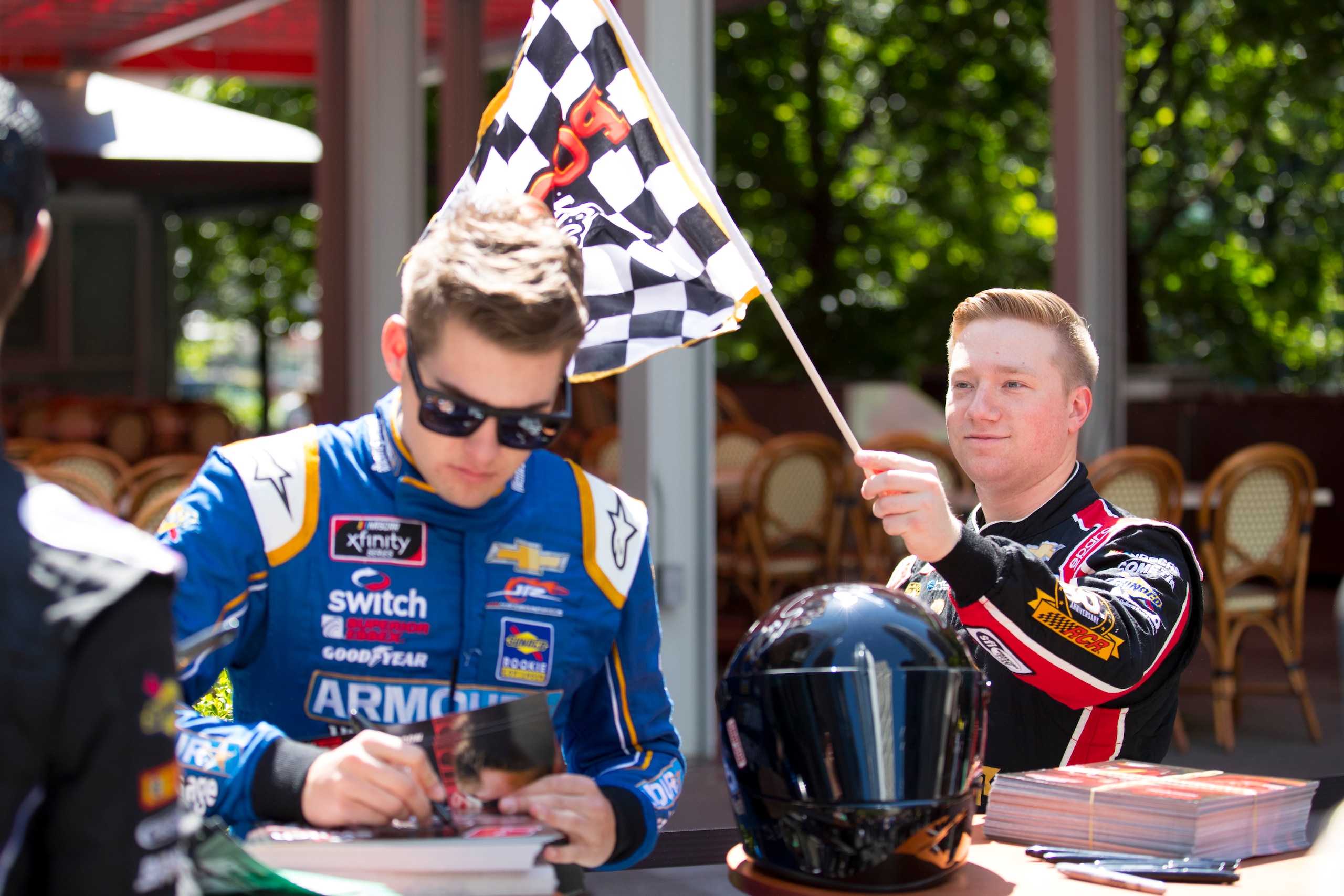 PHILADELPHIA, PA - MAY 15: Tyler Reddick, driver of the #2 Roland Chevrolet, waves a Pocono Raceway flag at Noah Gragson, driver of the #9 Switch Chevrolet at the 4th Annual NASCAR Xfinity Philadelphia Takeover on May 15, 2019 in Philadelphia, Pennsylvani