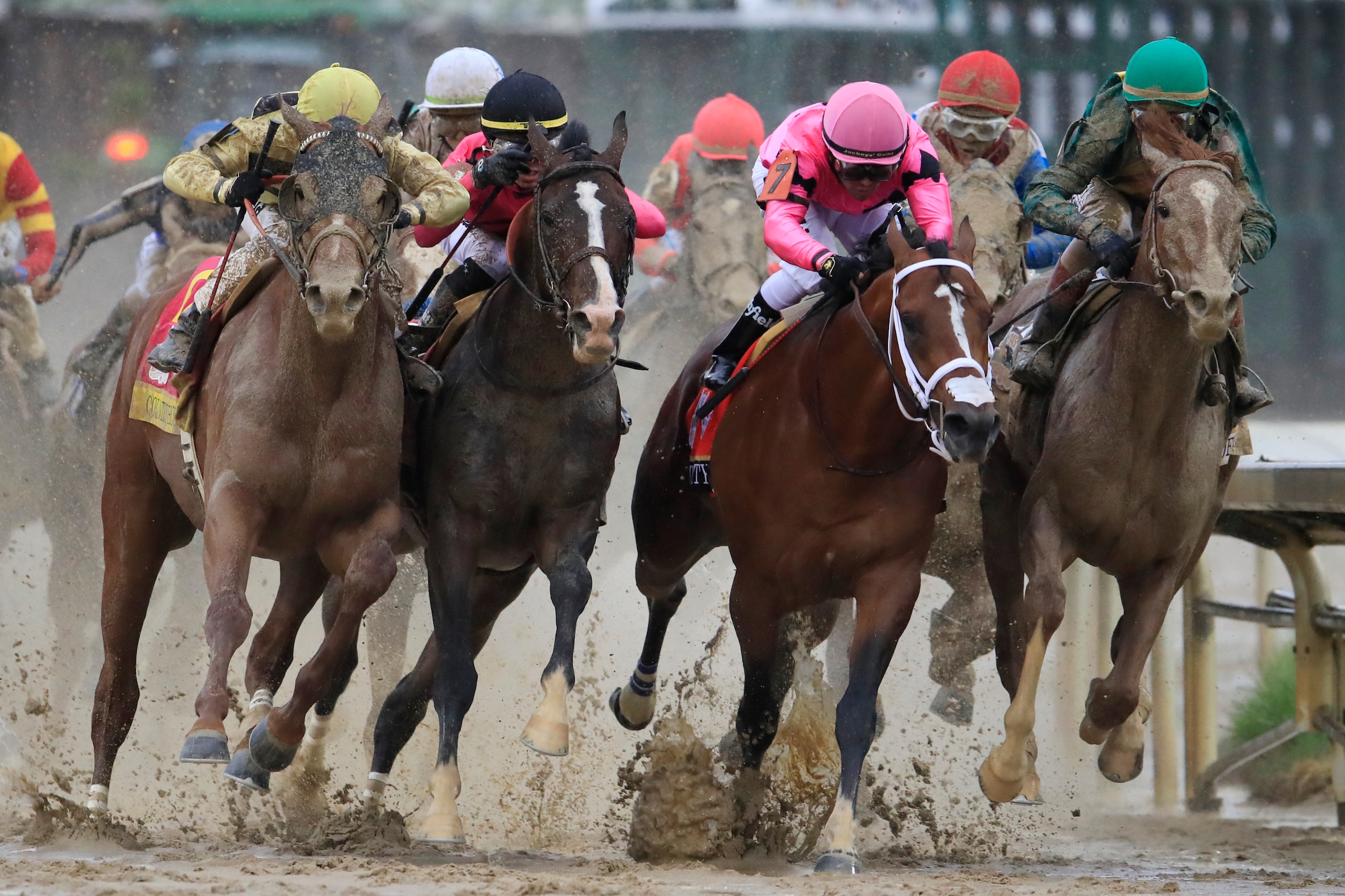 LOUISVILLE, KENTUCKY - MAY 04: Country House #20, ridden by jockey Flavien Prat, War of Will #1, ridden by jockey Tyler Gaffalione , Maximum Security #7, ridden by jockey Luis Saez and Code of Honor #13, ridden by jockey John Velazquez fight for position 