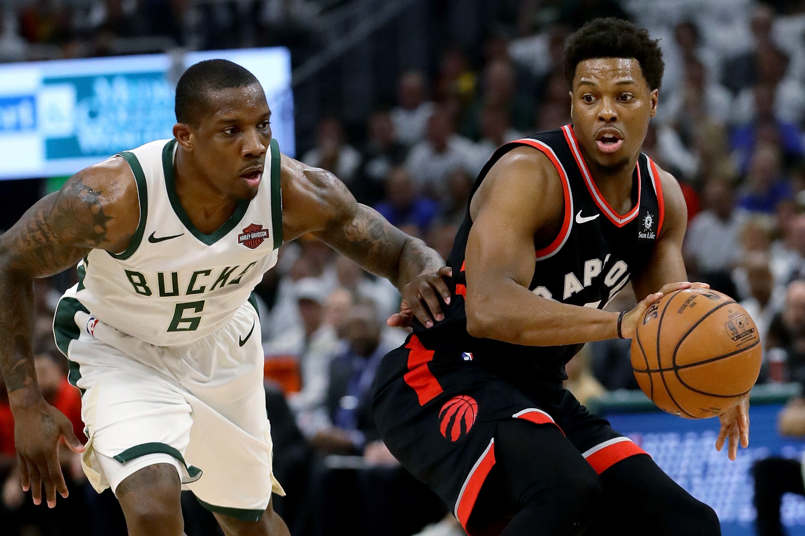 MILWAUKEE, WISCONSIN - MAY 15:  Kyle Lowry #7 of the Toronto Raptors dribbles the ball while being guarded by Eric Bledsoe #6 of the Milwaukee Bucks in the first quarter in Game One of the Eastern Conference Finals of the 2019 NBA Playoffs at the Fiserv F