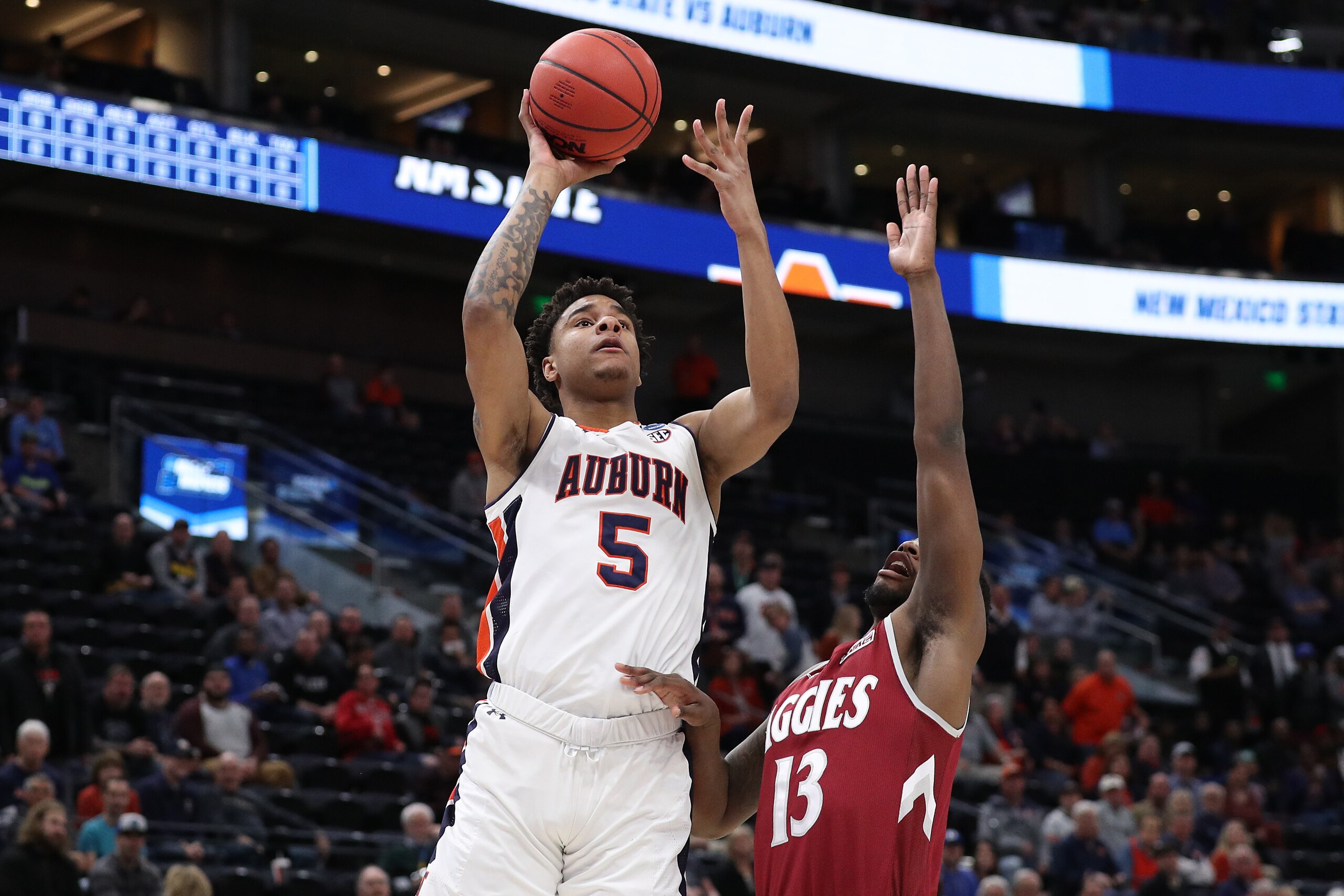SALT LAKE CITY, UTAH - MARCH 21: Chuma Okeke #5 of the Auburn Tigers shoots the ball against C.J. Bobbitt #13 of the New Mexico State Aggies during the first half in the first round of the 2019 NCAA Men's Basketball Tournament at Vivint Smart Home Arena o