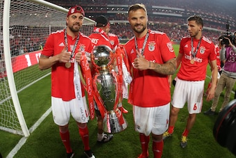 LISBON, PORTUGAL - MAY 18: Haris Seferovic of SL Benfica and Jardel of SL Benfica celebrate with trophy after winning the Liga NOS Championship at the end of the Liga NOS match between SL Benfica and CD Santa Clara at Estadio da Luz on May 18, 2019 in Lis