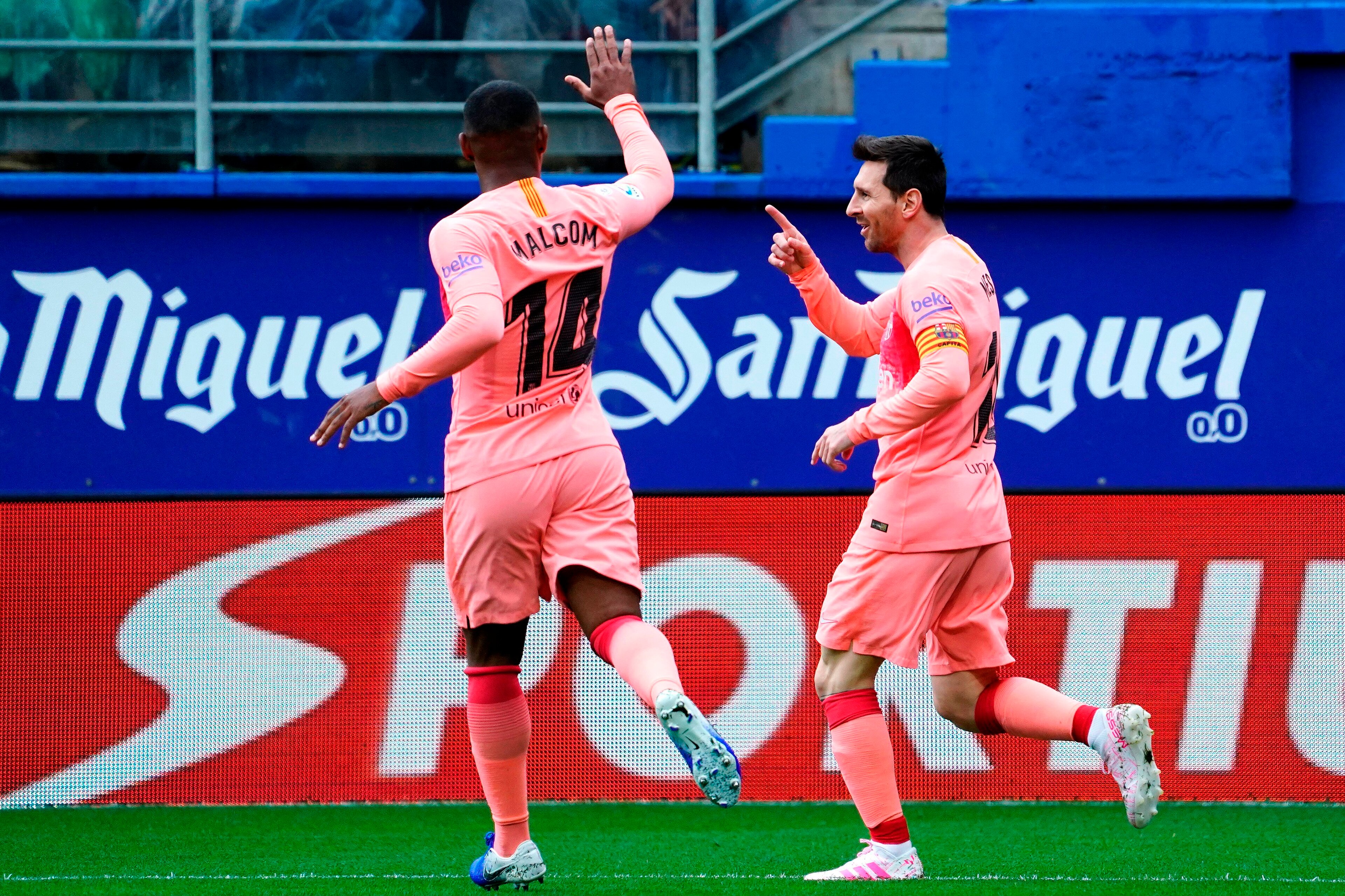 Barcelona's Argentinian forward Lionel Messi (R) celebrates with Barcelona's Brazilian midfielder Malcom after scoring a goal during the Spanish League football match between Eibar and Barcelona at the Ipurua stadium in Eibar on May 19, 2019. (Photo by ST