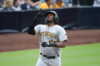 SAN DIEGO, CA - MAY 18: Josh Bell #55 of the Pittsburgh Pirates points skyward after hitting a solo home run during the second inning of a baseball game against the San Diego Padres at Petco Park May 18, 2019 in San Diego, California.  (Photo by Denis Por