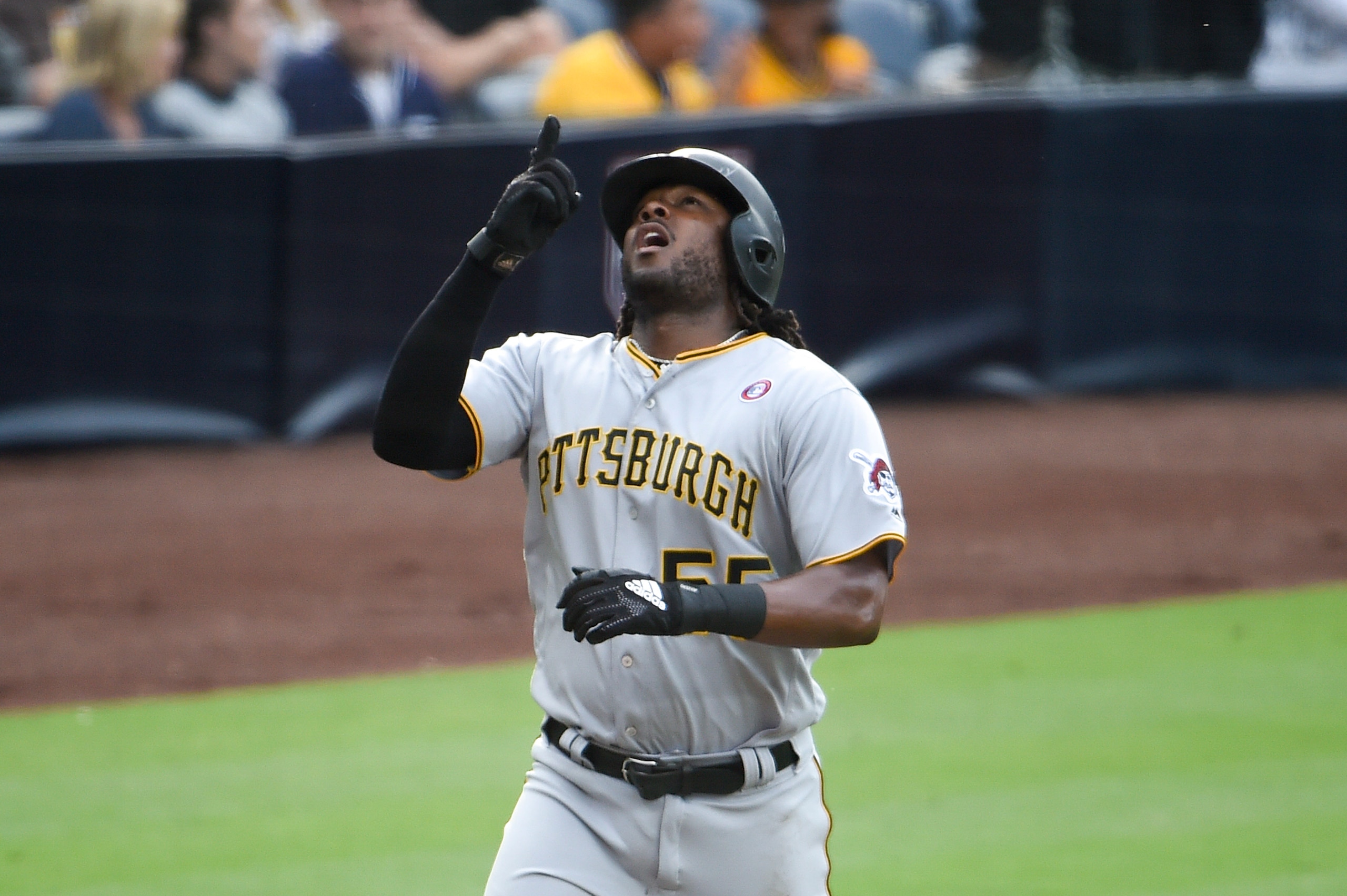 SAN DIEGO, CA - MAY 18: Josh Bell #55 of the Pittsburgh Pirates points skyward after hitting a solo home run during the second inning of a baseball game against the San Diego Padres at Petco Park May 18, 2019 in San Diego, California.  (Photo by Denis Por